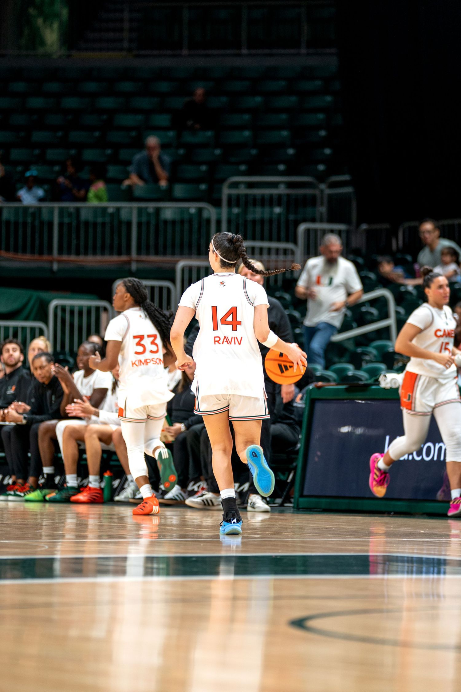 Players stretch on the basketball court before a game at the University of Miami.