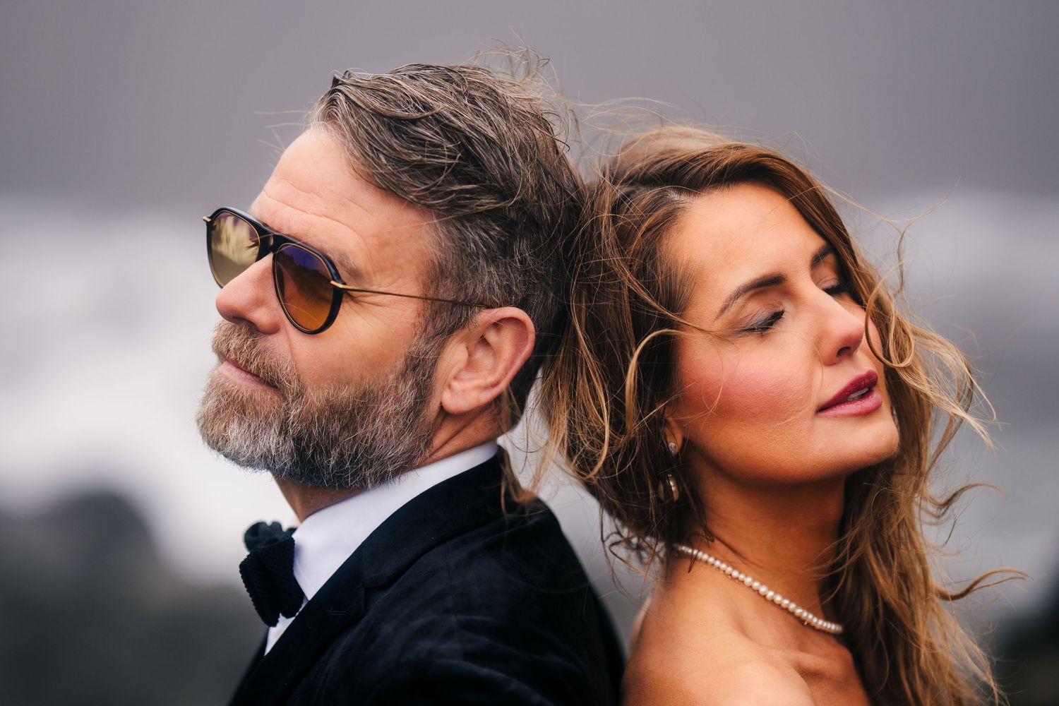 Iceland destination wedding. A couple in formal attire poses together at a glamorous event on a red carpet.