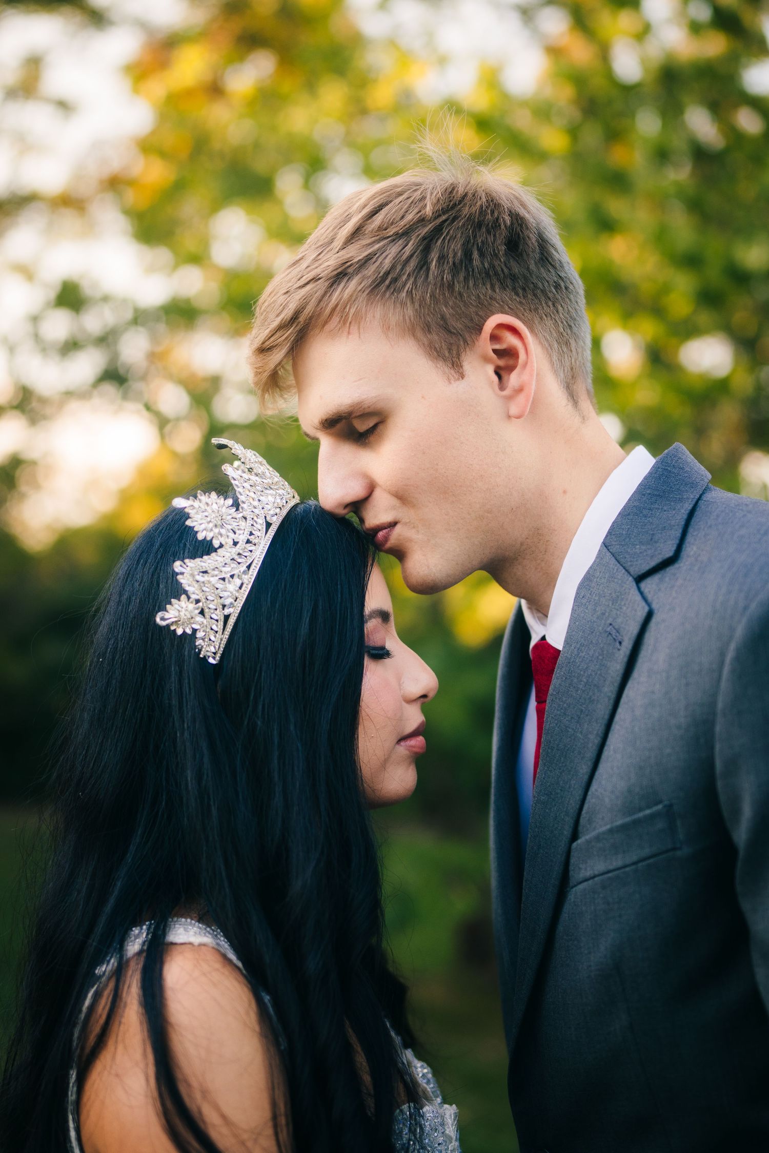 Mississauga wedding portrait. romantic wedding couple sharing an intimate moment outdoors with autumn foliage in the background.