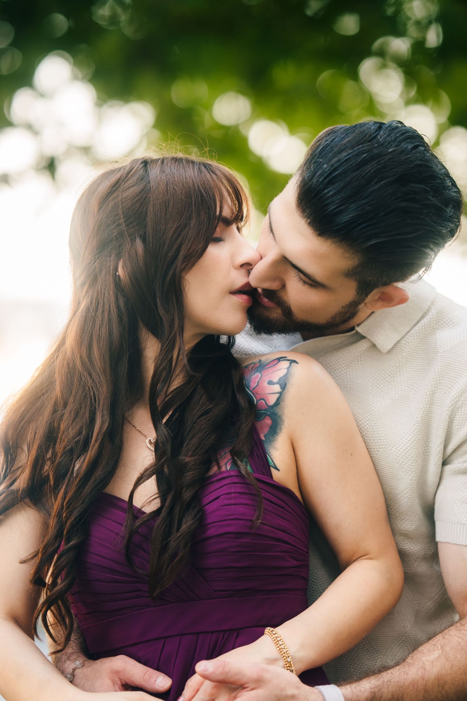 CN Tower Harborfront Proposal. A couple in a romantic outdoor setting shares intimate moments against a blurred natural background.