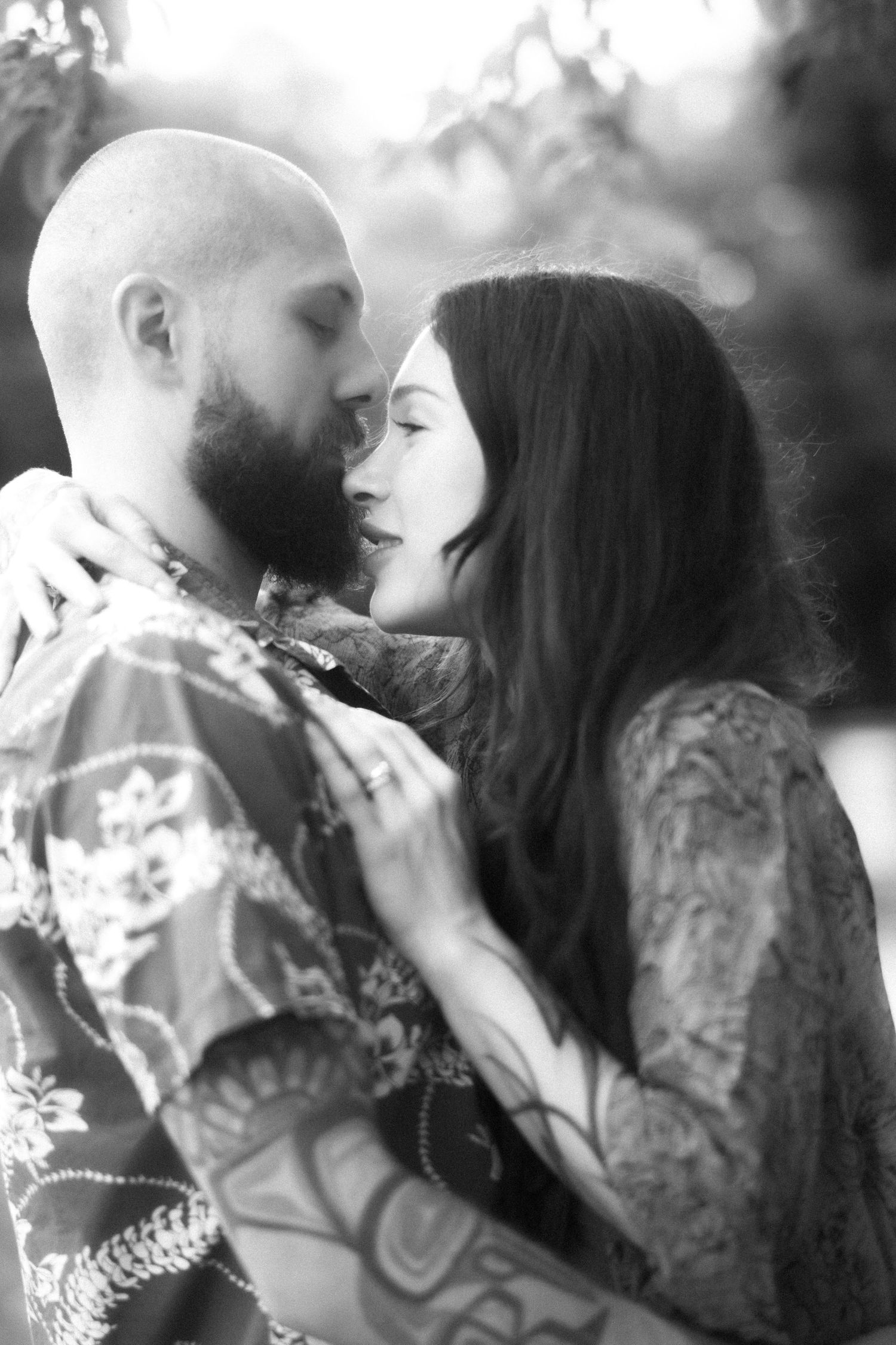 A romantic black and white photo sequence showing a couple sharing intimate kisses in matching floral outfits.