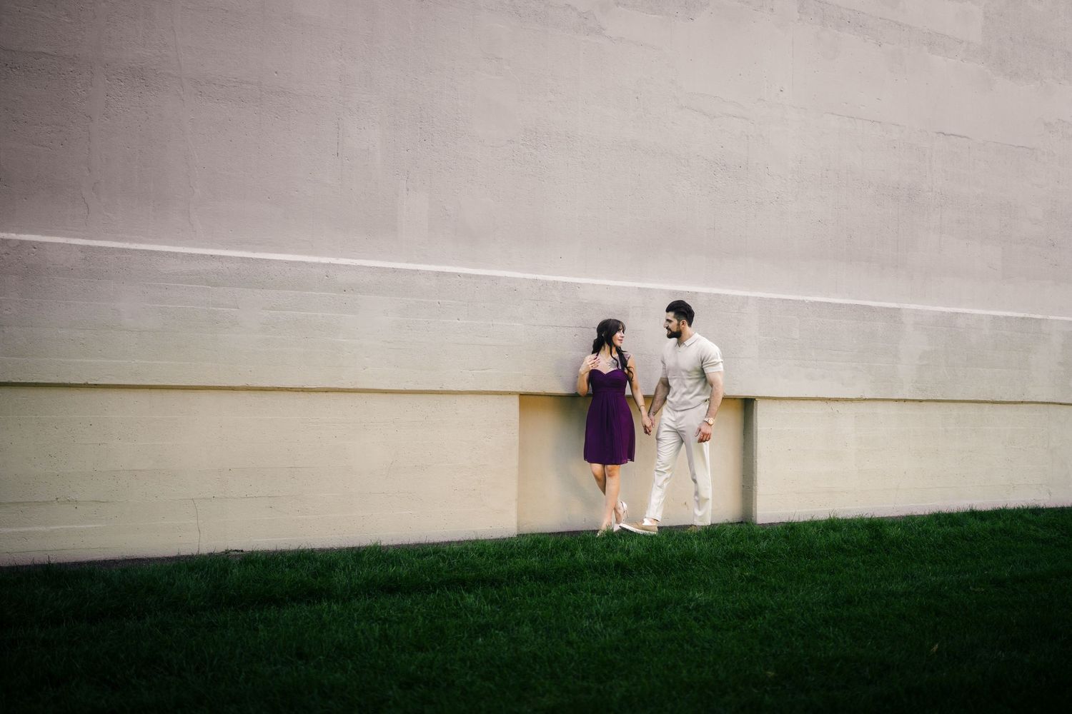 CN Tower Harborfront Proposal showing people walking against concrete walls and grassy slopes in an urban setting.