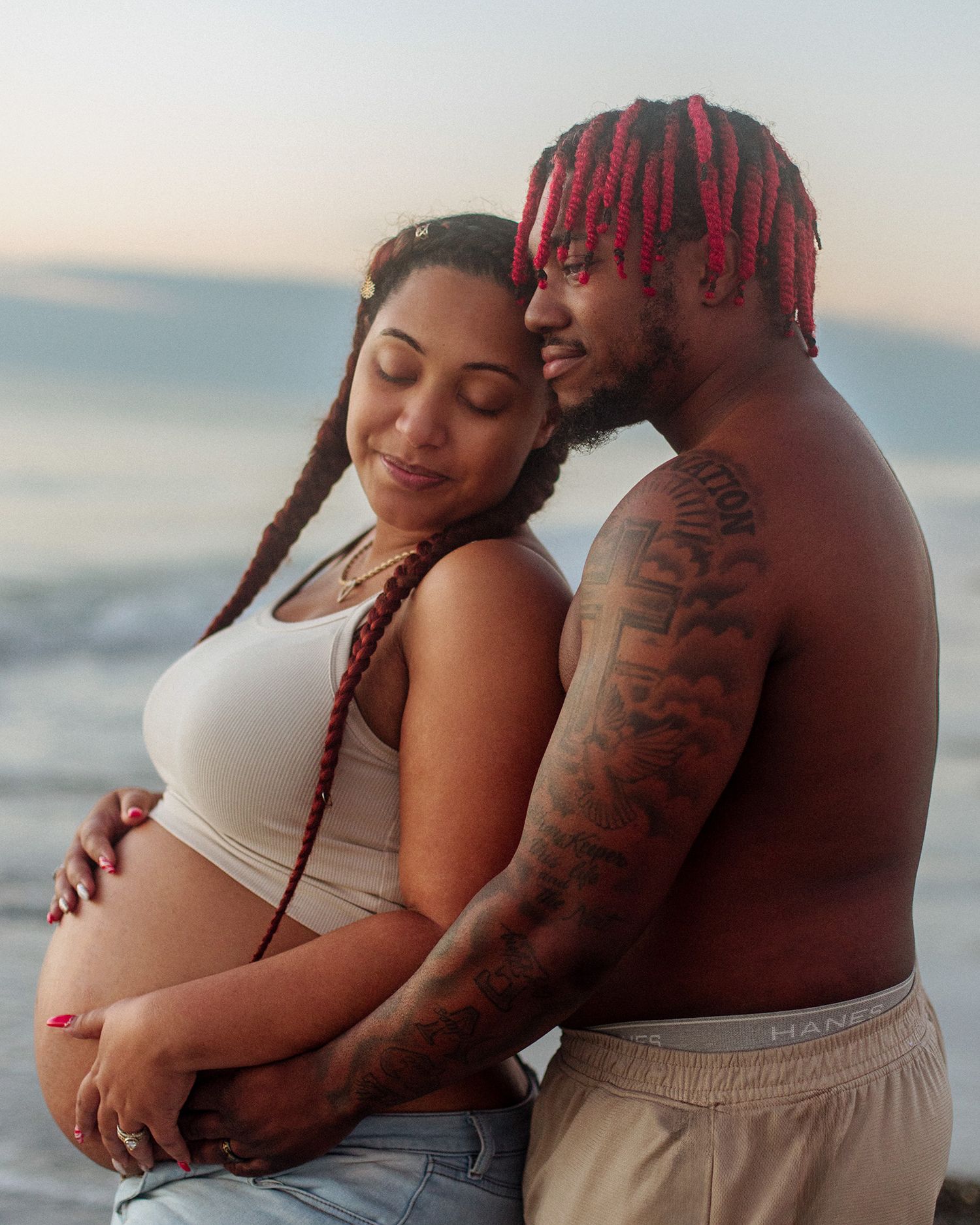 Redington Beach outdoor maternity photos of couple on beach embracing