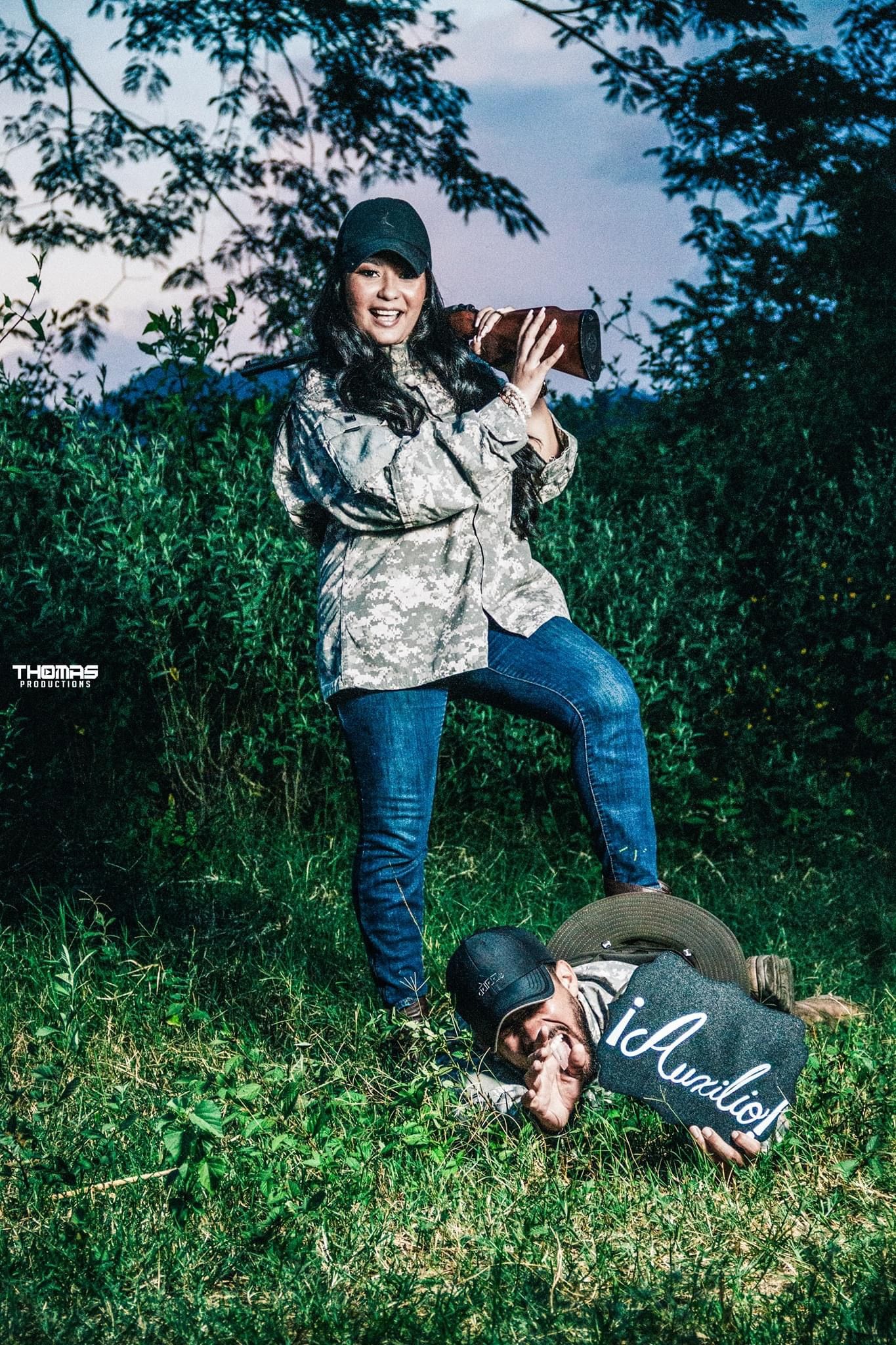 Playful outdoor photoshoot with creative poses in a green natural setting.