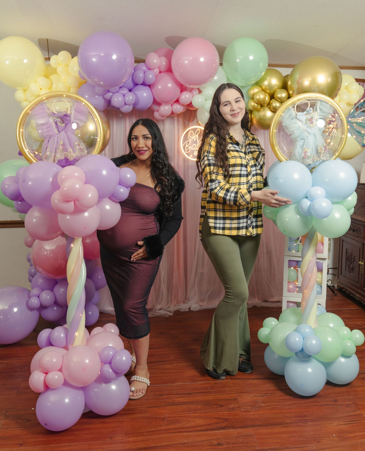 Colorful balloon decorations in pastel shades create a festive indoor party atmosphere.