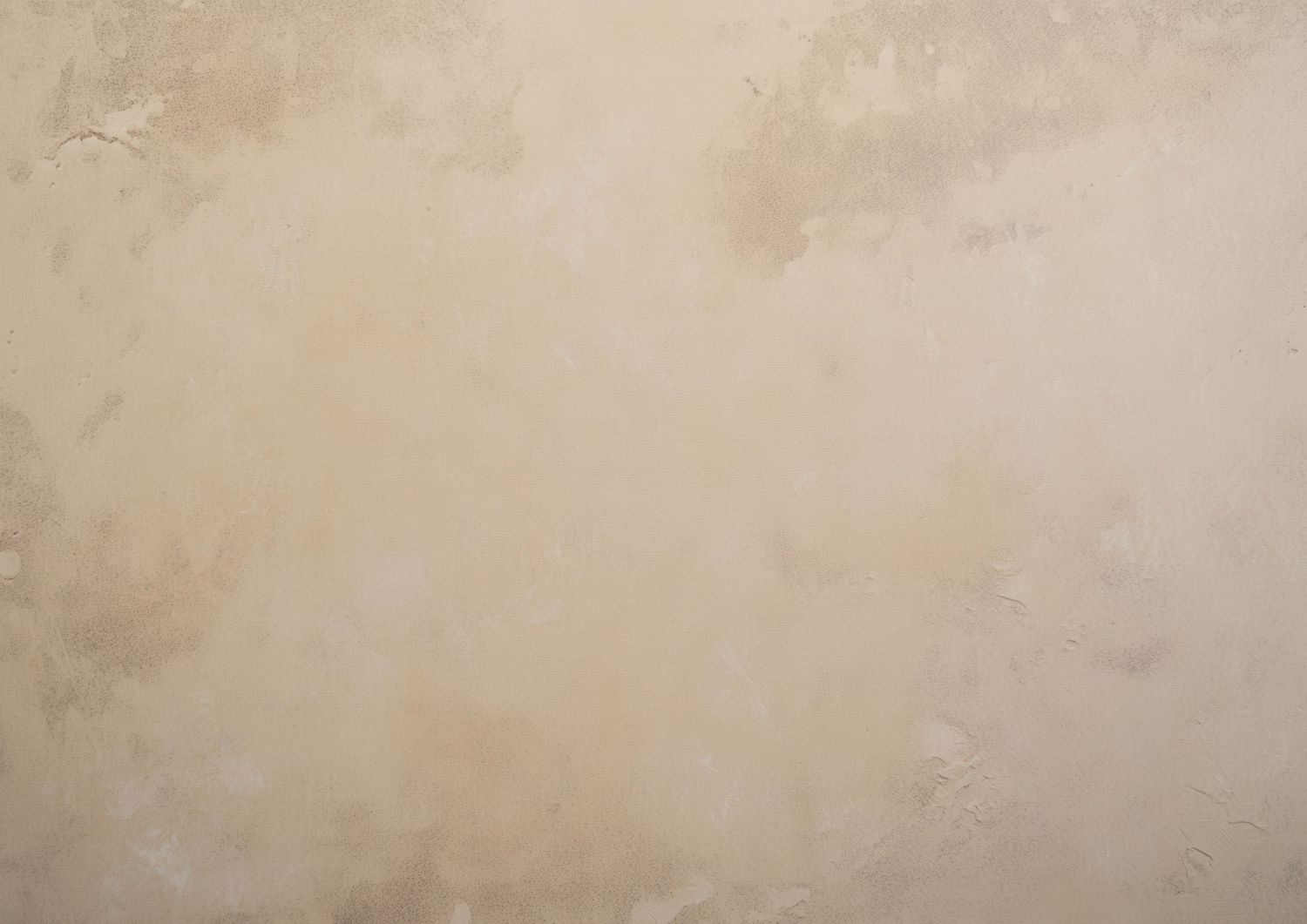 Beige textured plaster wall background with subtle variations in tone, ideal for design projects.