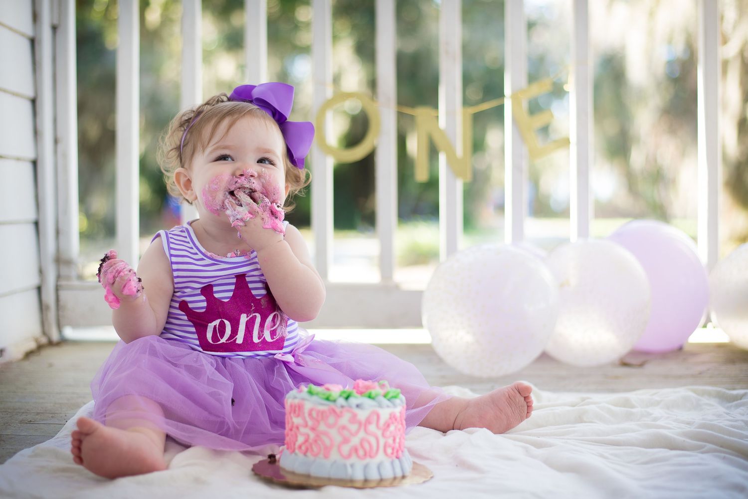 Cake smash or milestone portrait of baby girl with floral headband — Alexandra Hall Photography, Alpine Groves Park Jacksonville FL