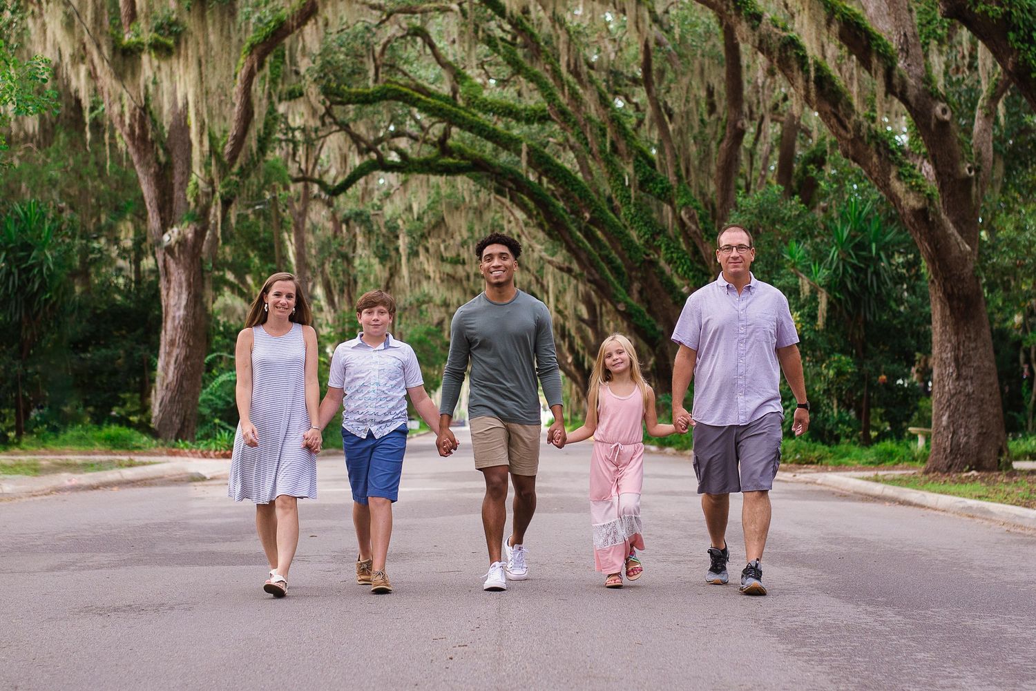 Family walking together under Spanish moss oaks — natural light portrait session, Jacksonville and St Augustine FL by Alexandra Hall