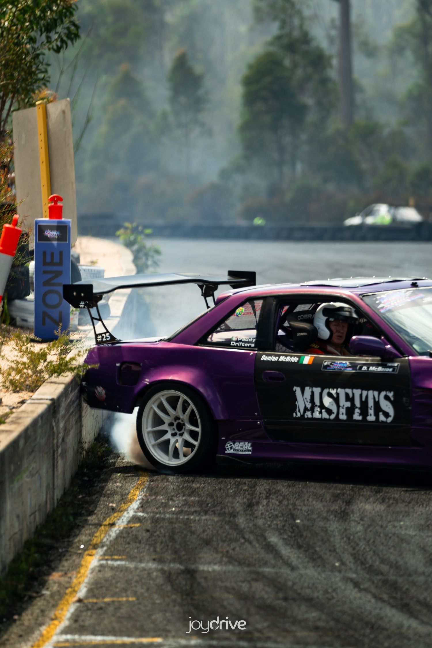 Purple S13 car with Misfits livery smoking at track.