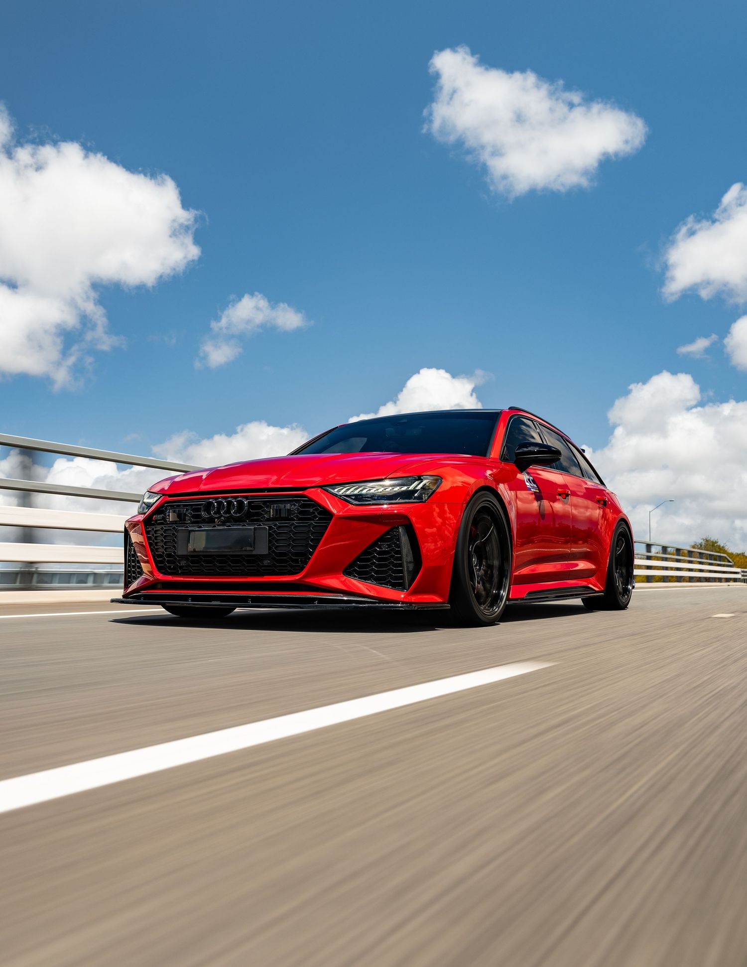 Red Audi RS6 Avant performance wagon rolling shot on a highway