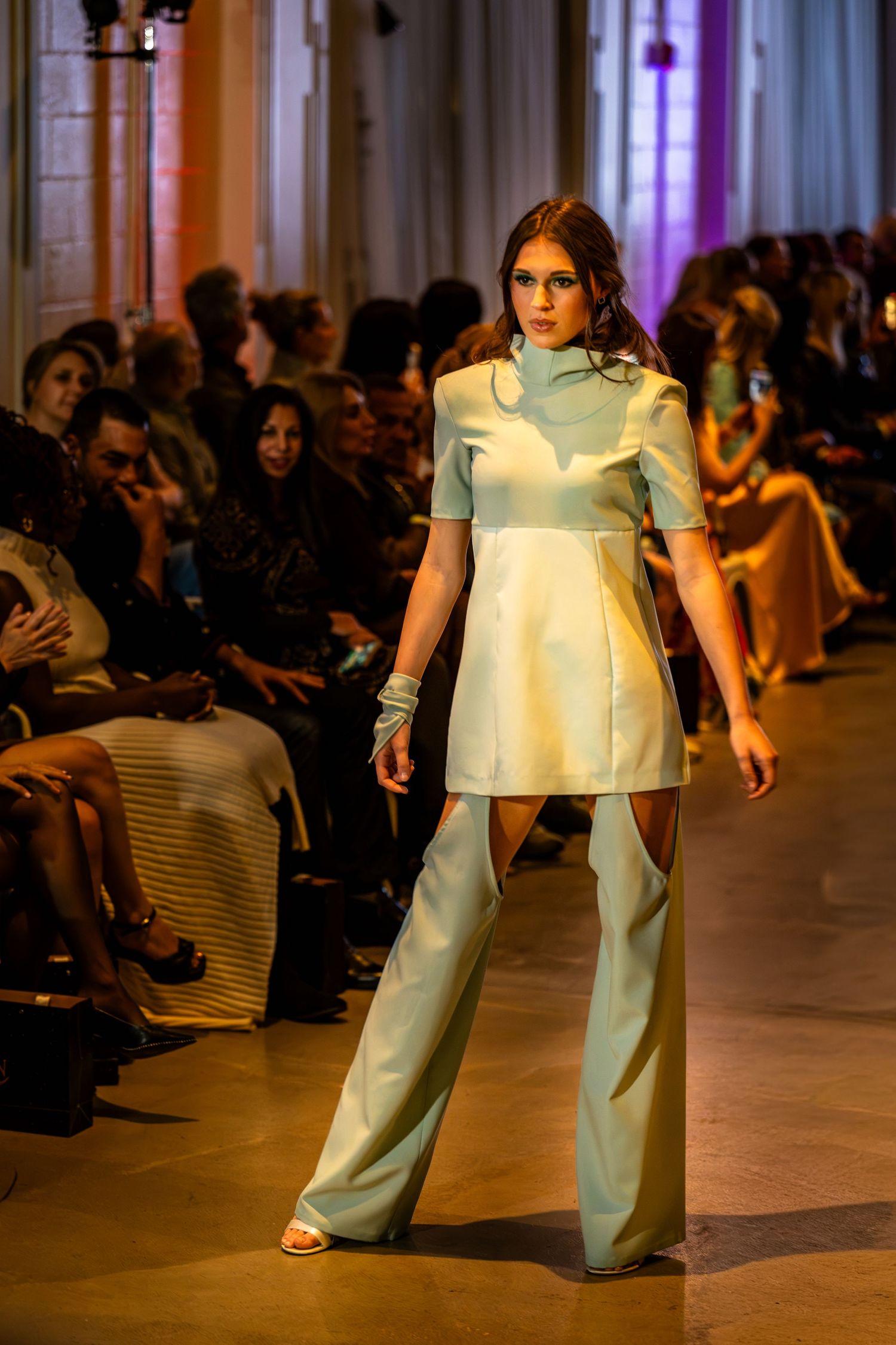 Model wearing a mint-green tunic and matching wide-leg trousers at Charlotte Fashion Week.