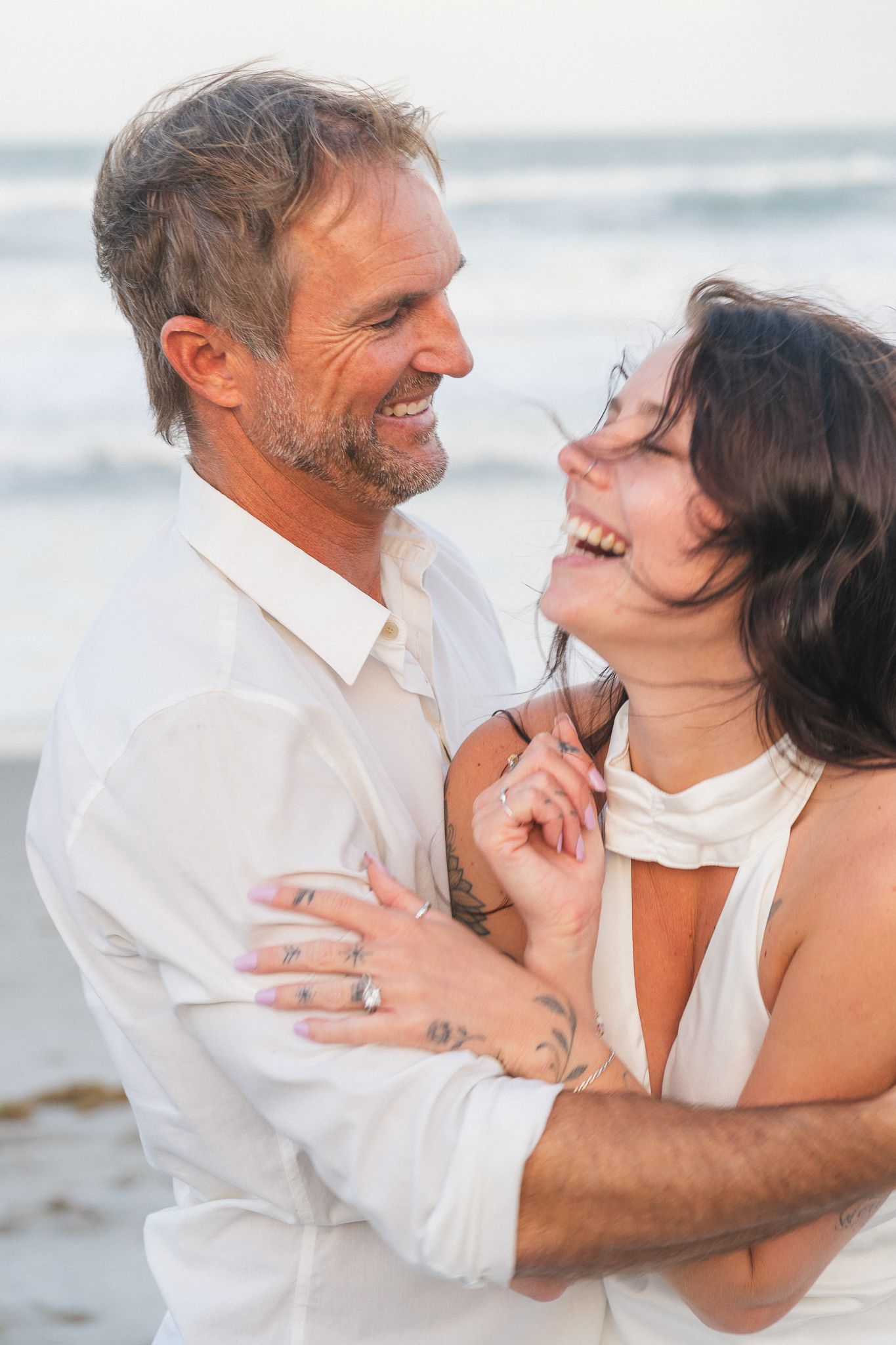 Light and airy beach couples engagement photography session on Brevard County beach