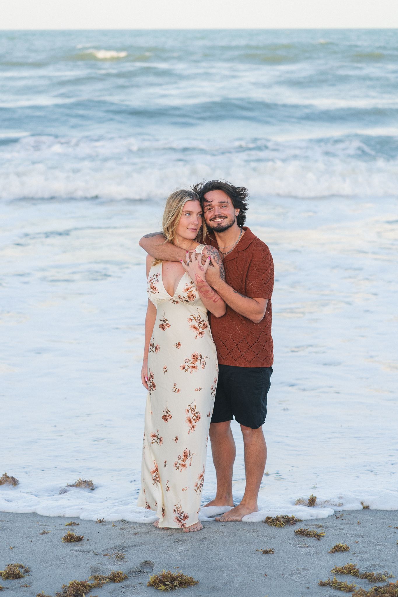 Couple embracing at sunset on Melbourne Beach, Florida engagement session