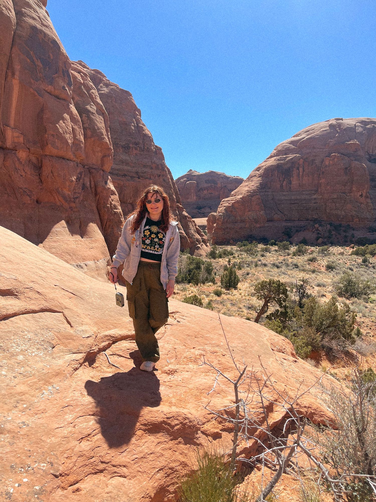 Photo of me holding my phone camera in Moab, Utah — travel photography, nostalgic and soulful moment.