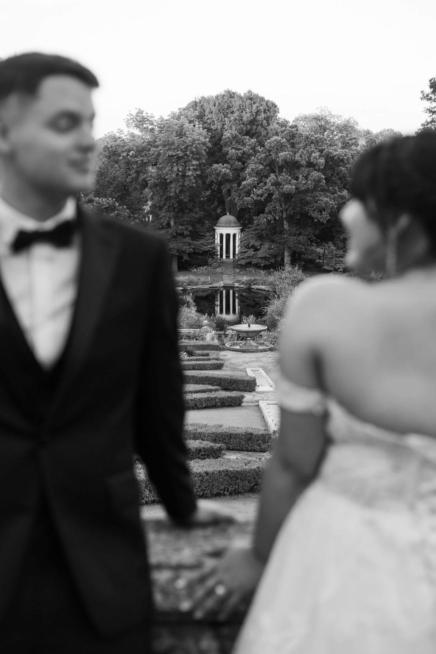 A black and white wedding photo sequence showing a couple in formal attire standing in a garden with a gazebo.