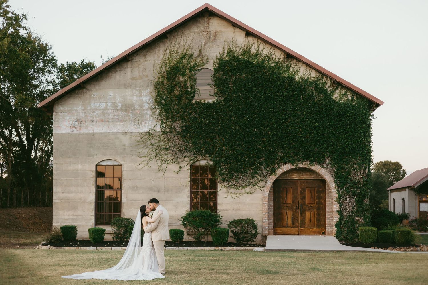 Rustic stone barn wedding venue with elegant landscaping and natural surroundings.