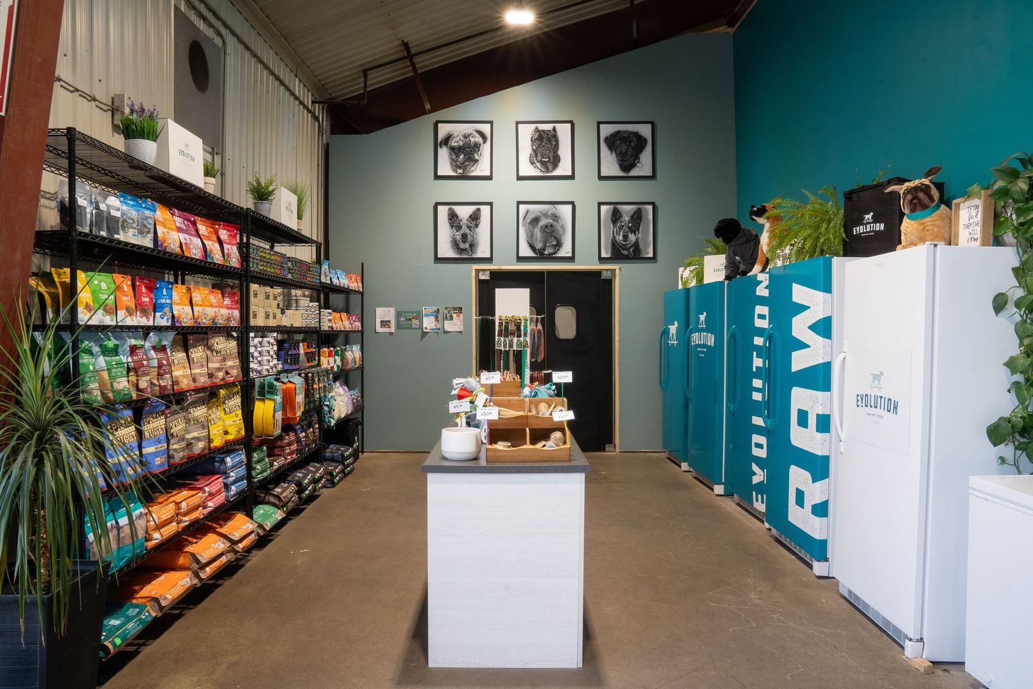 Interior view of a convenience store showing refrigerators, snack shelves and retail displays in a modern space.