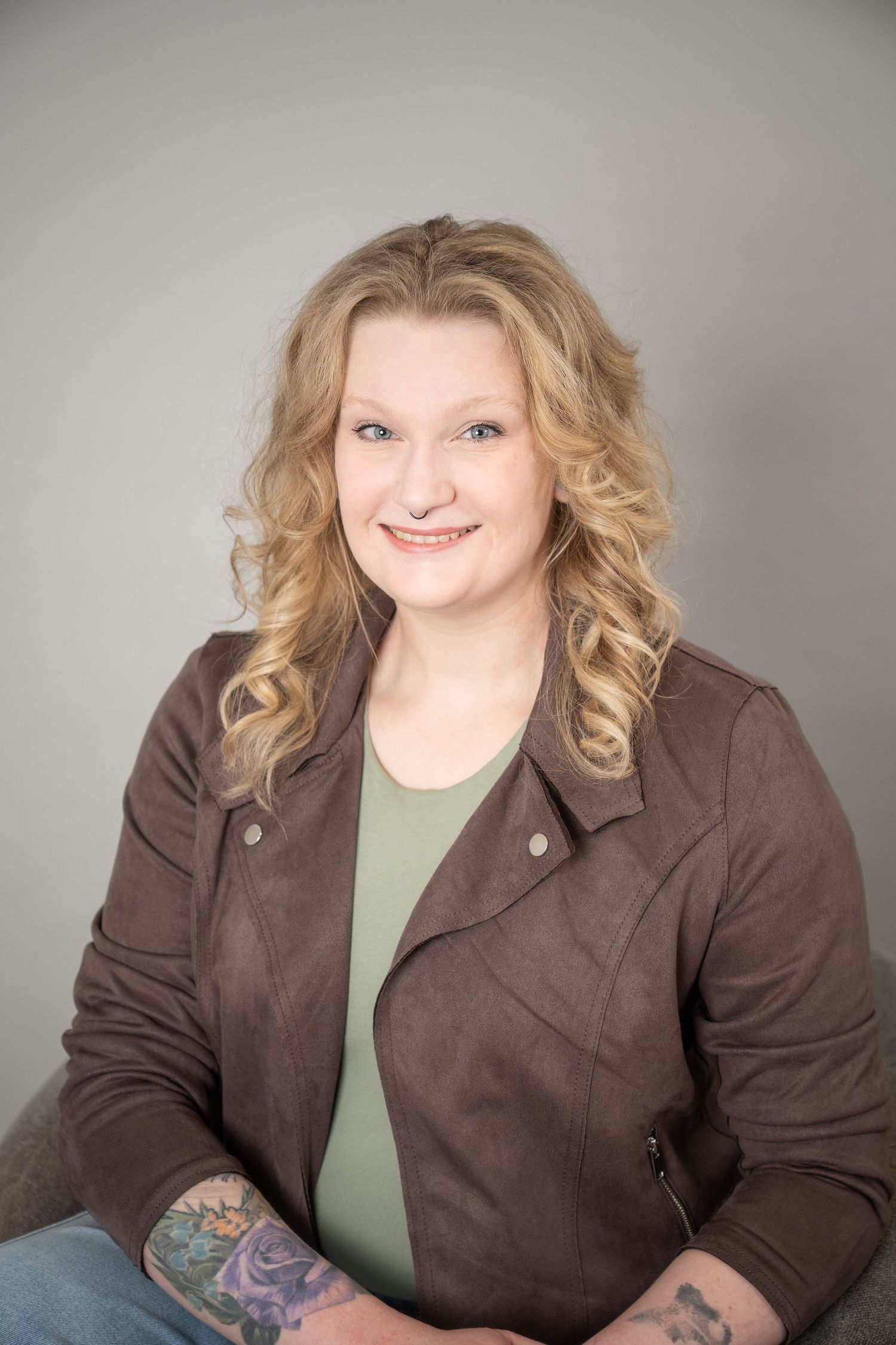 Professional headshot series showing person in brown blazer and olive top with wavy blonde hair against gray background.