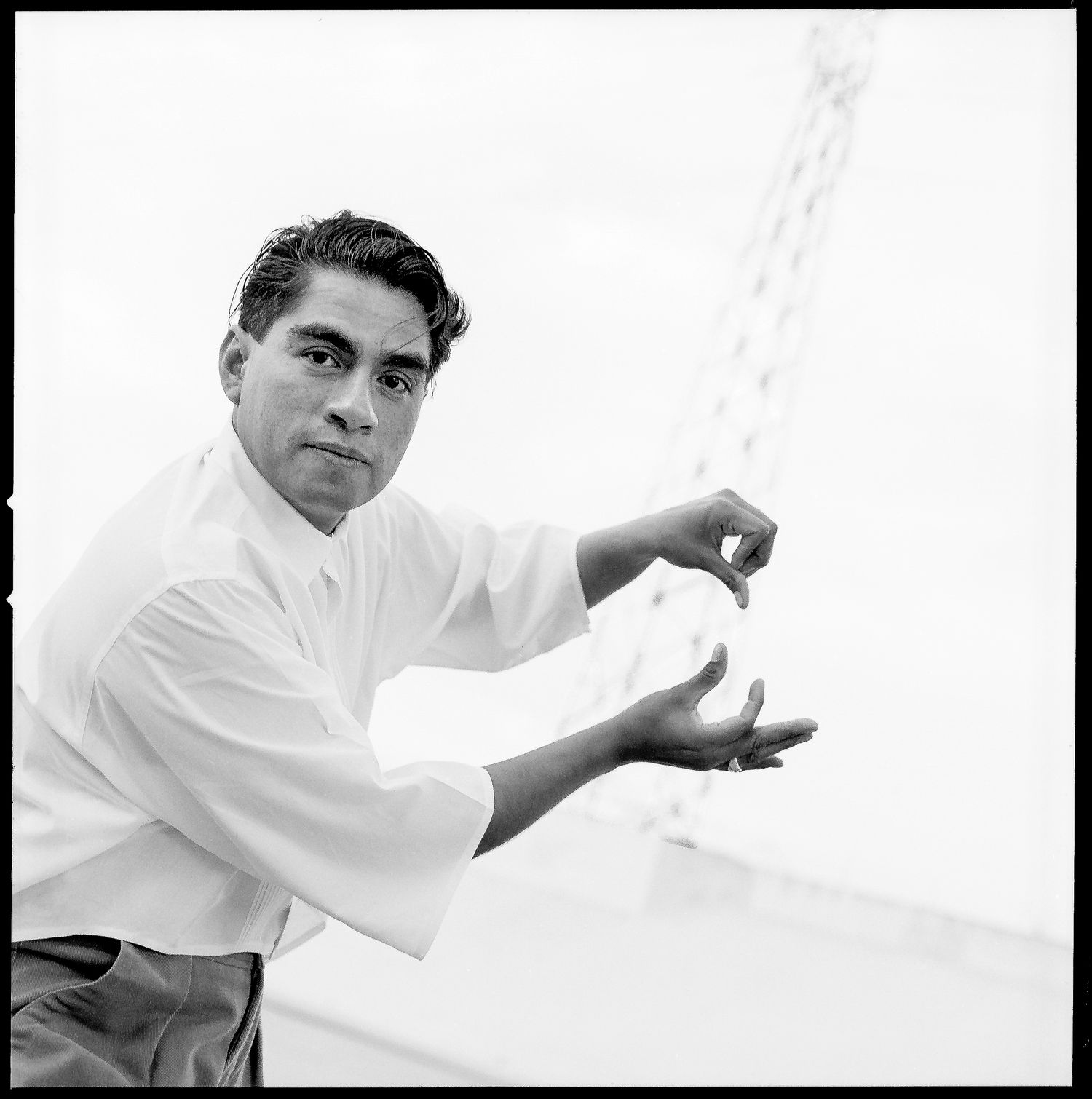 Richard Duardo , artist and printmaker by the L.A. river, flashing hand signs
