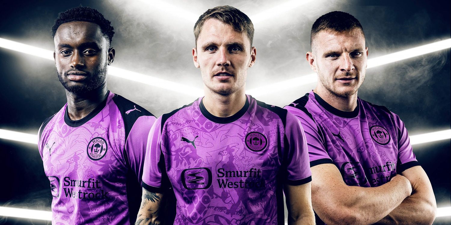 3 football players looking at the camera with smoke and glowing lights behind them
