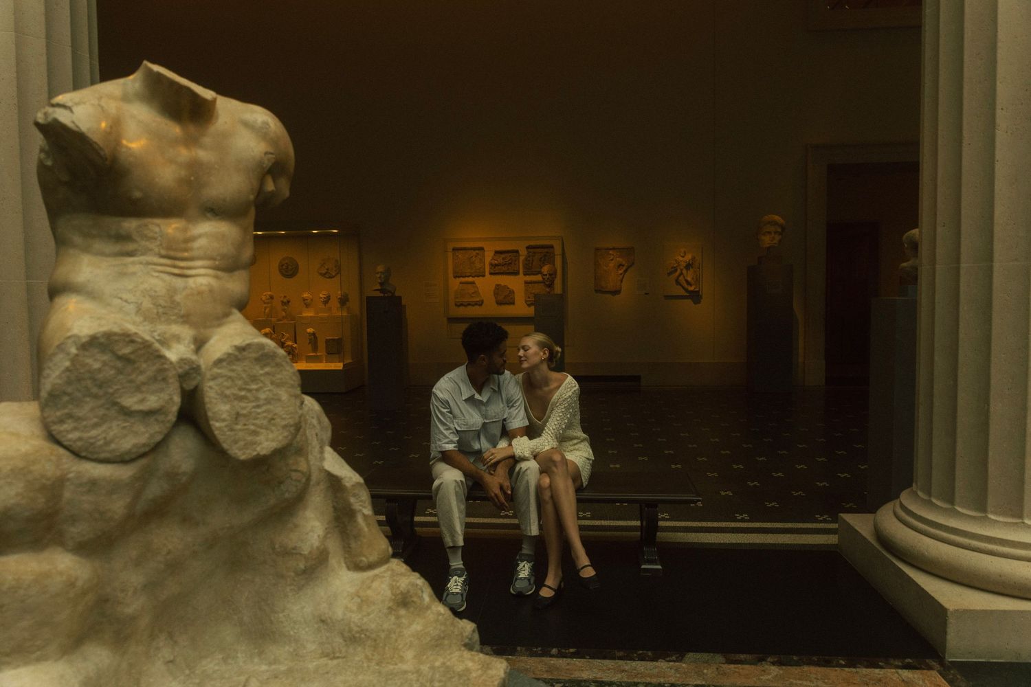 Interior museum gallery space with classical sculptures and columns. NYC, The MET