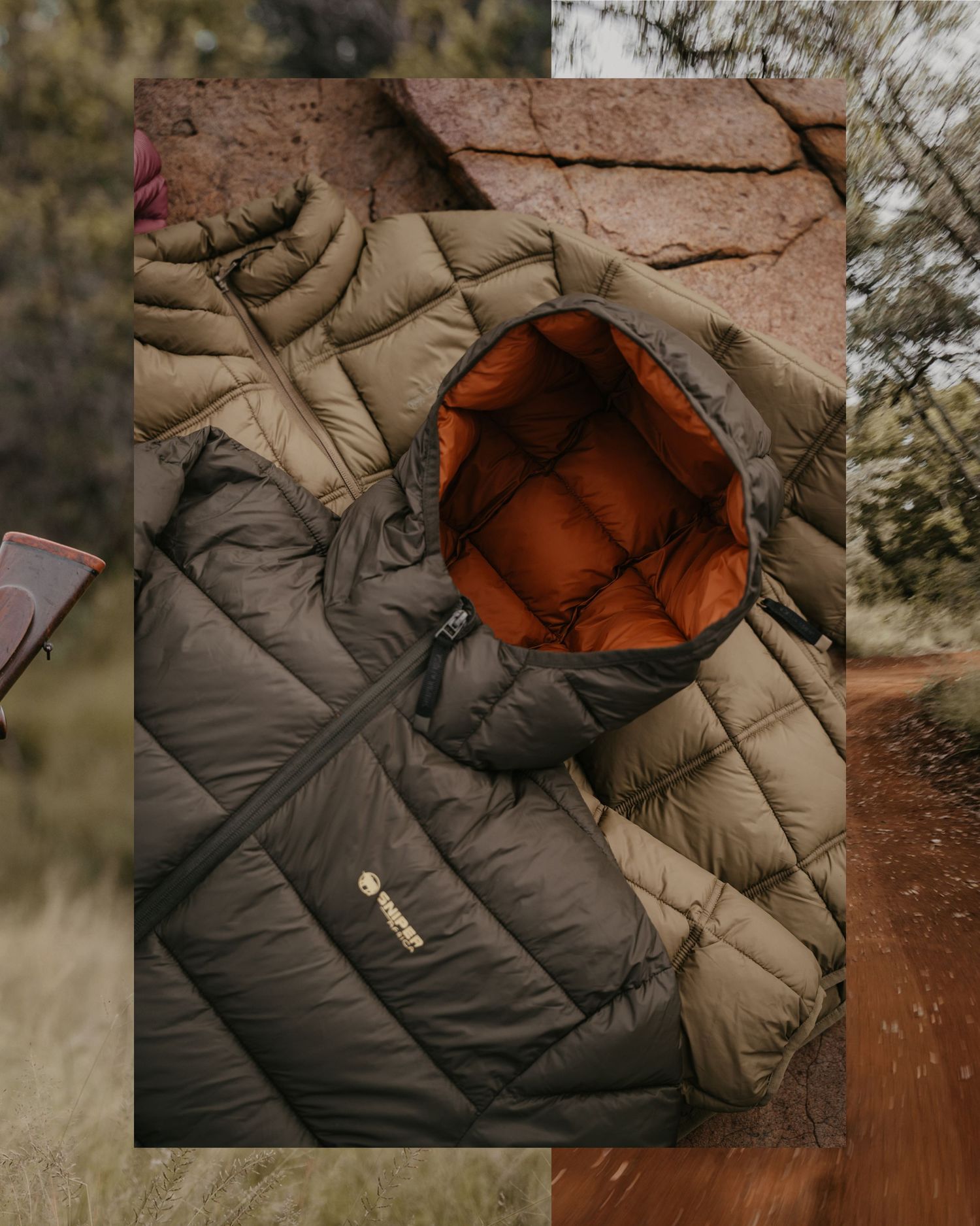 Olive green quilted down jacket with orange lining displayed on rocky outdoor terrain.