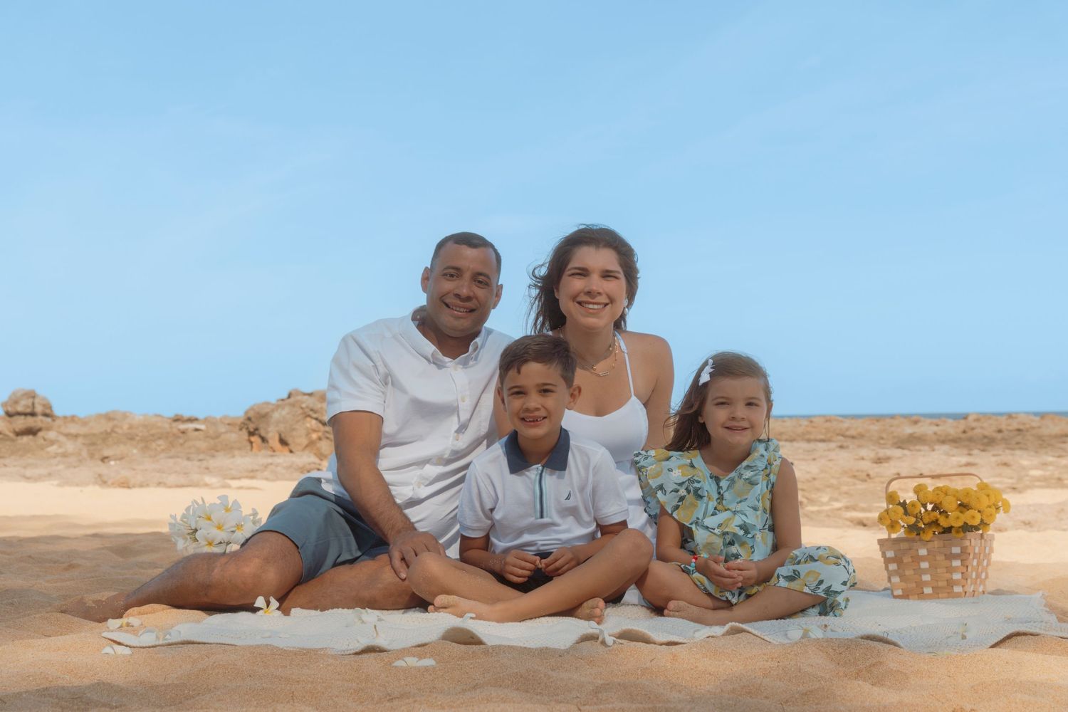 Sunset beach family session with warm natural light and tropical skies