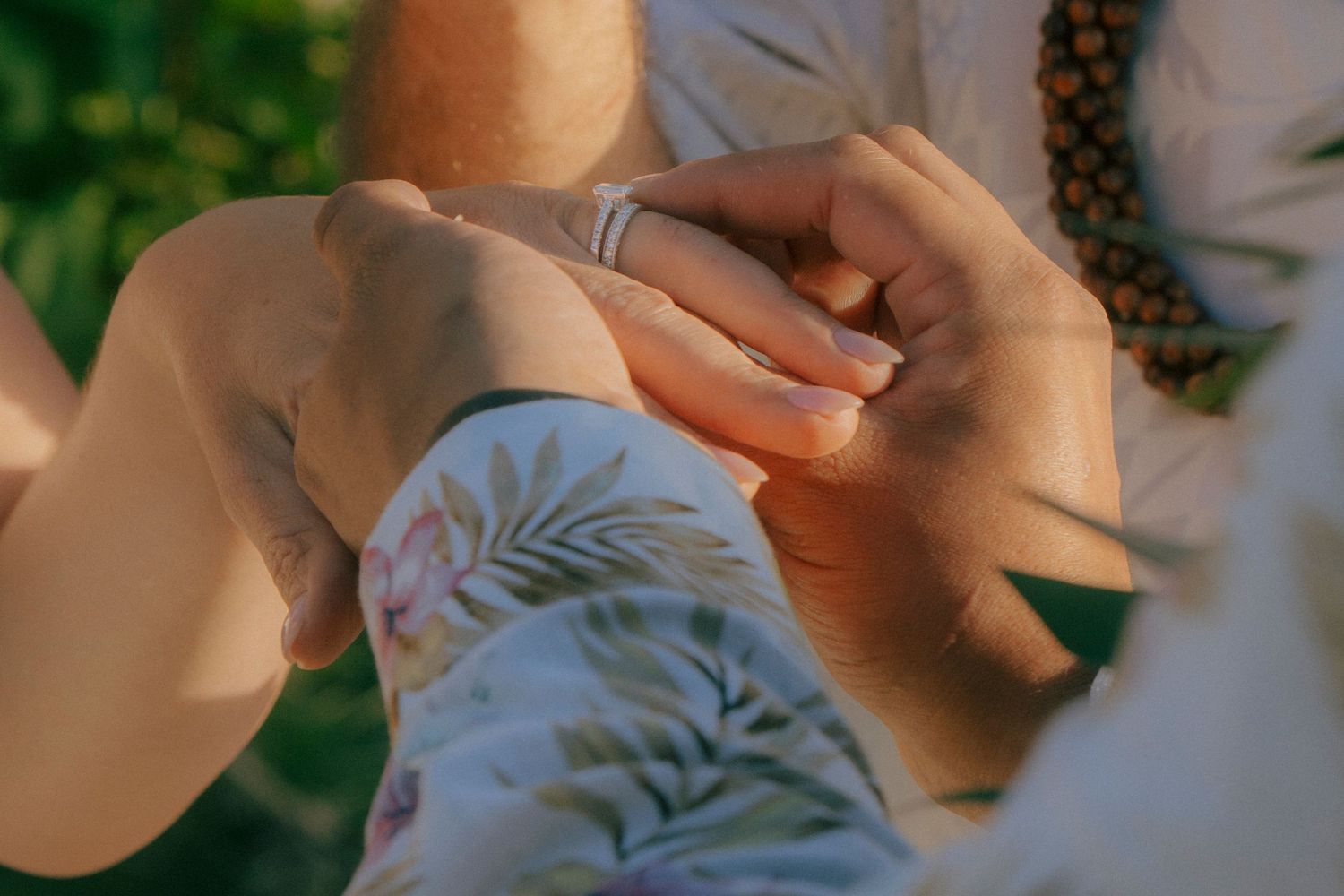Groom placing ring on brides finger during North Shore beach elopement