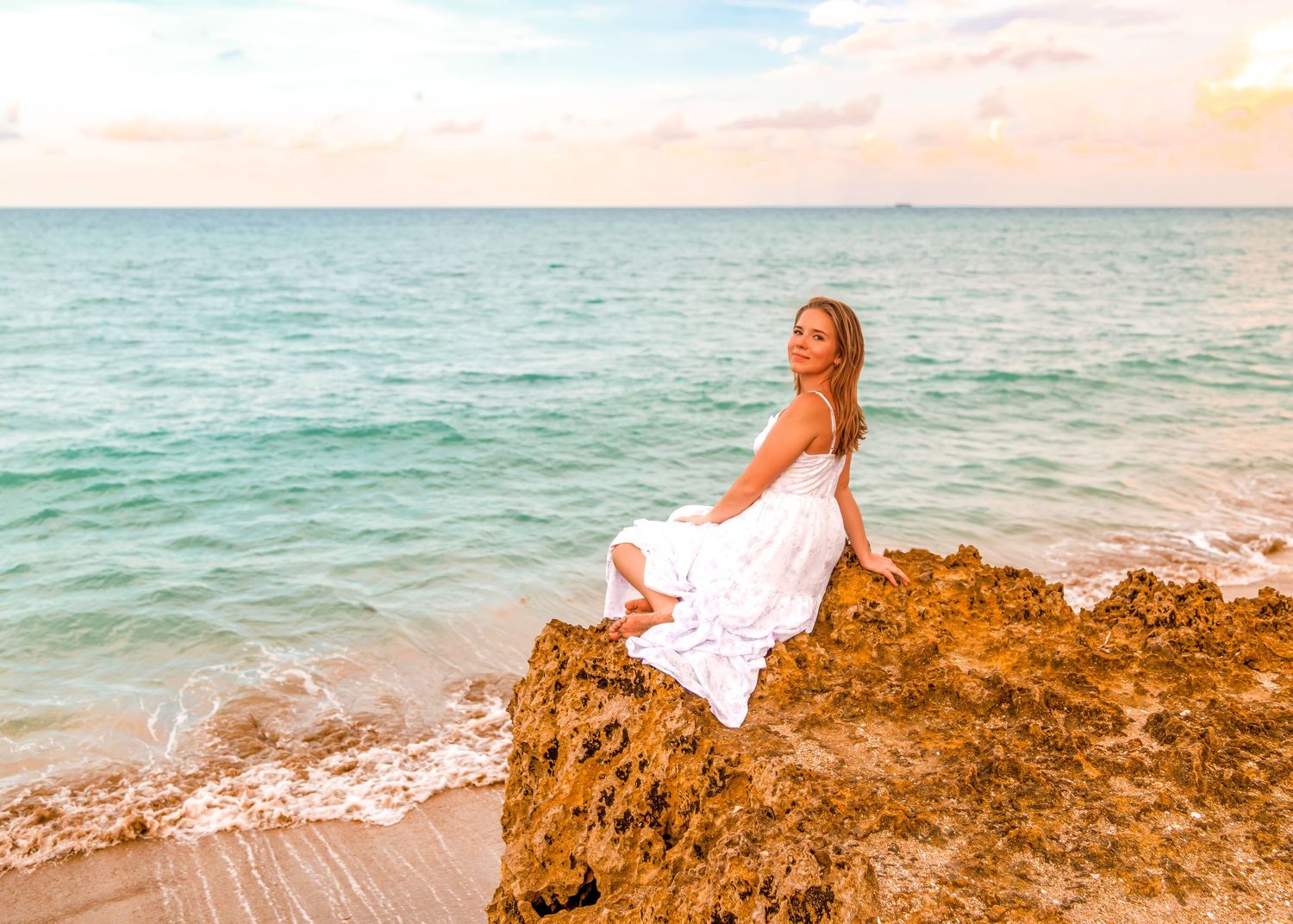 A series of beach scenes at sunset with sand, rocks and ocean waves meeting the shoreline against a warm sky.