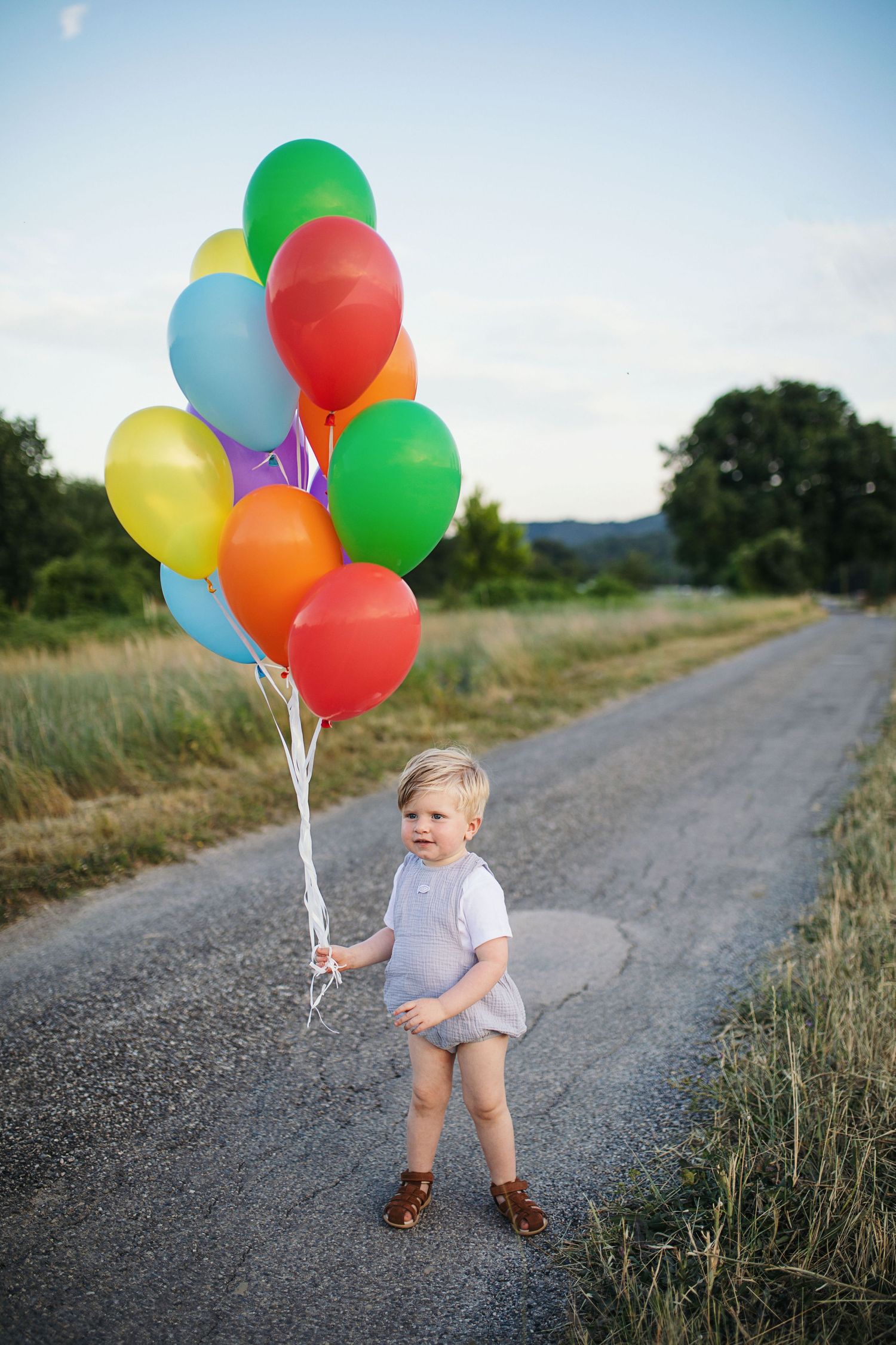 Séance photo enfants, famille anniversaire. Enfant tenant des ballons