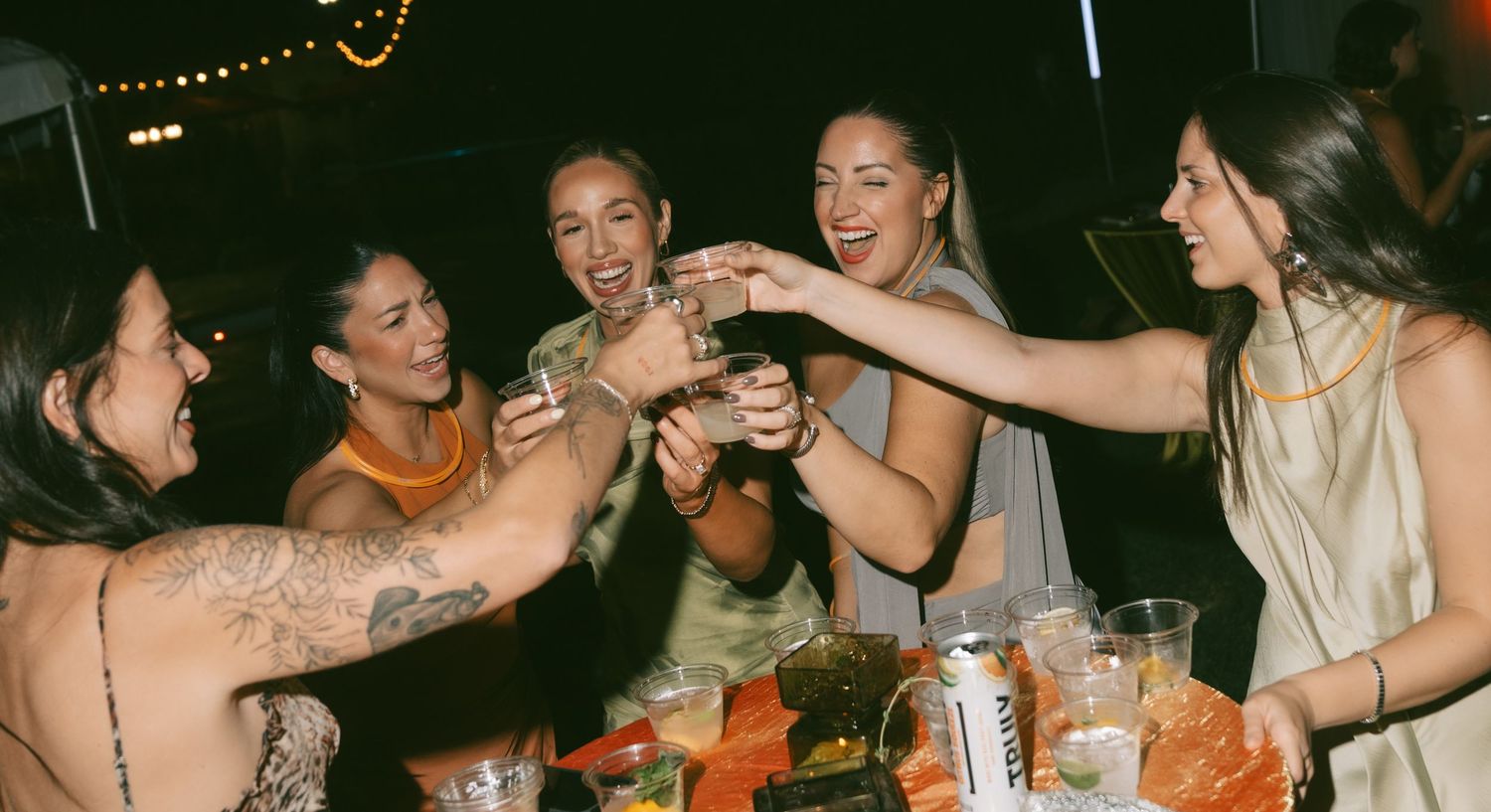 Candid party scene with people celebrating and dancing together.
