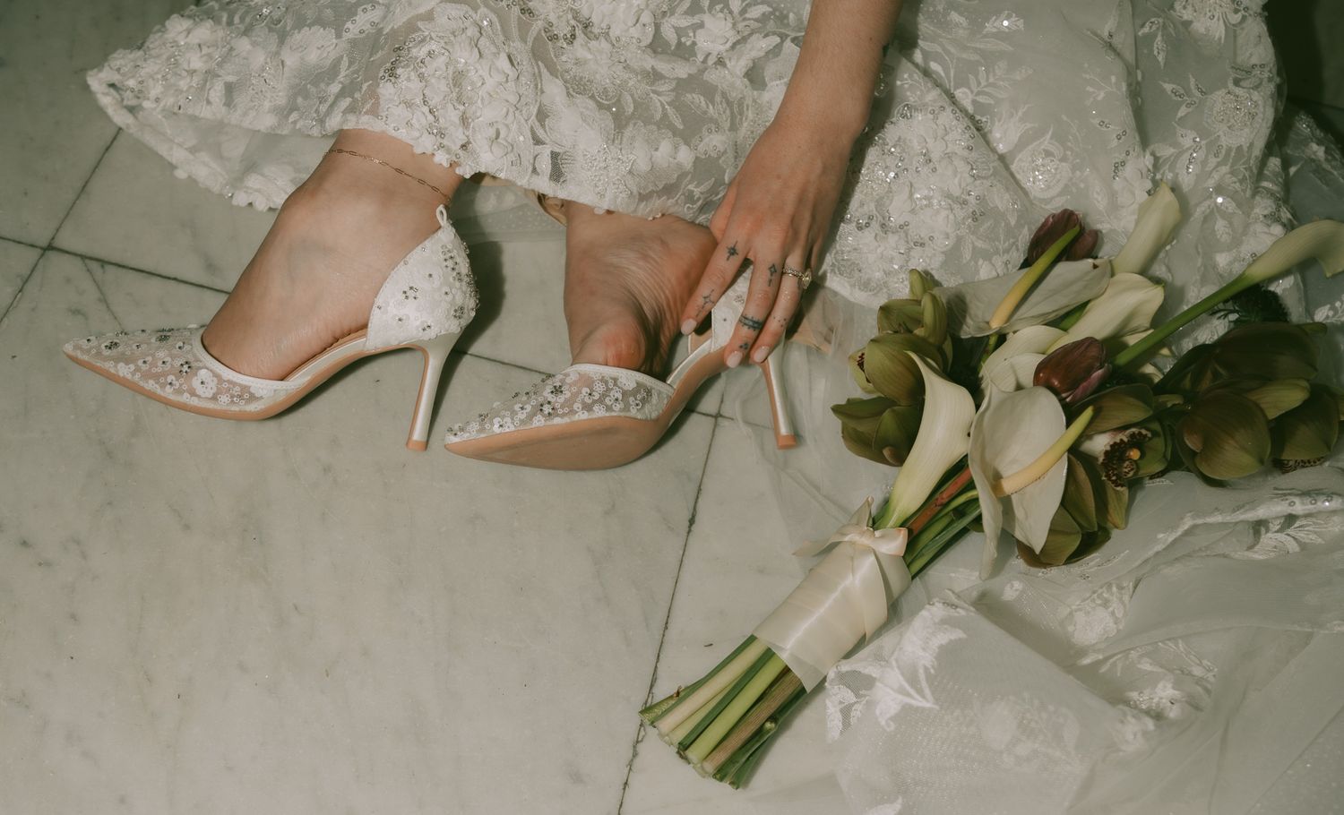 Wedding detail shots of white floral bouquet and bridal shoes on light marble floor in Pittsburgh.
