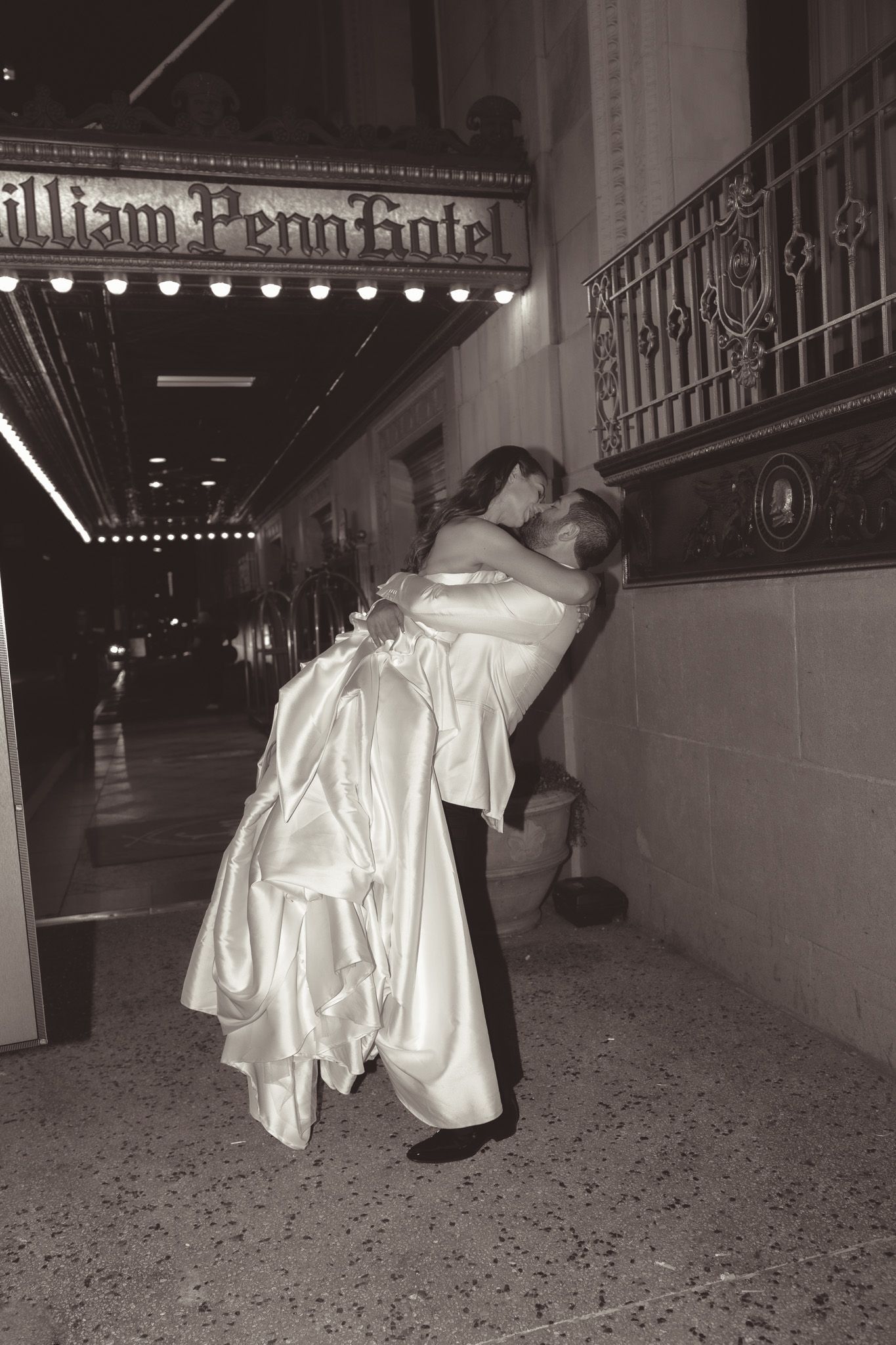 Romantic flash portrait moment outside William Penn Hotel with couple in wedding attire in downtown pittsburgh, pa.