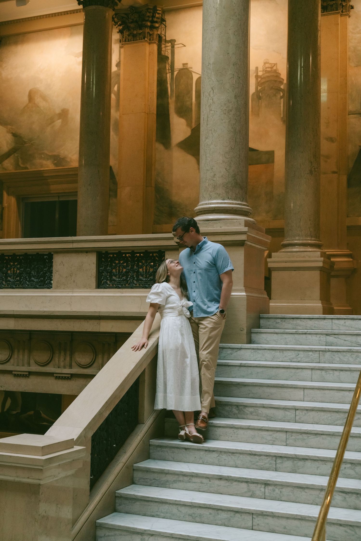 Sequence of photos showing marble steps and columns in an elegant classical building interior.