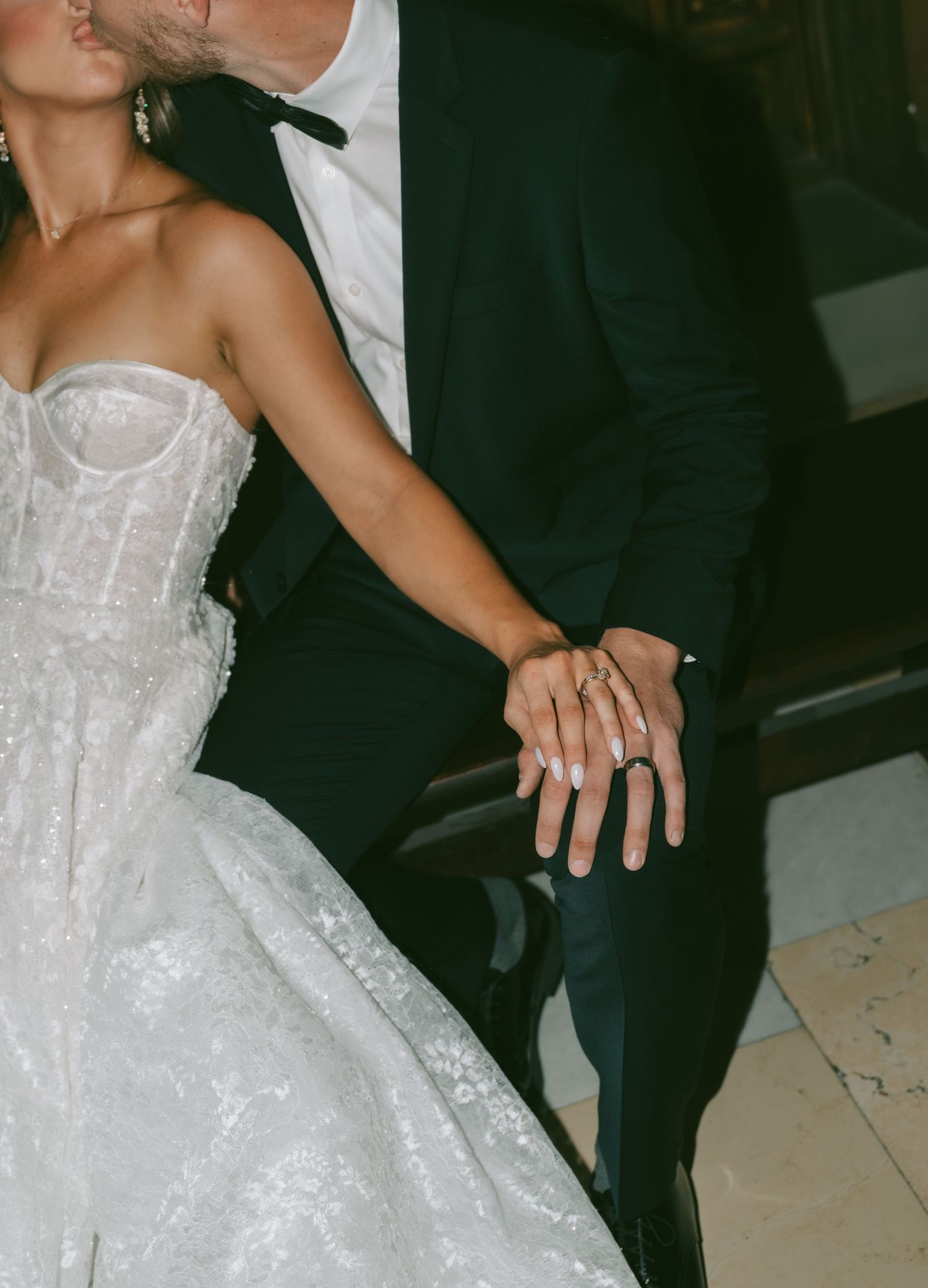 Artistic wedding portraits capturing tender moments between bride in white gown and groom in black tuxedo.