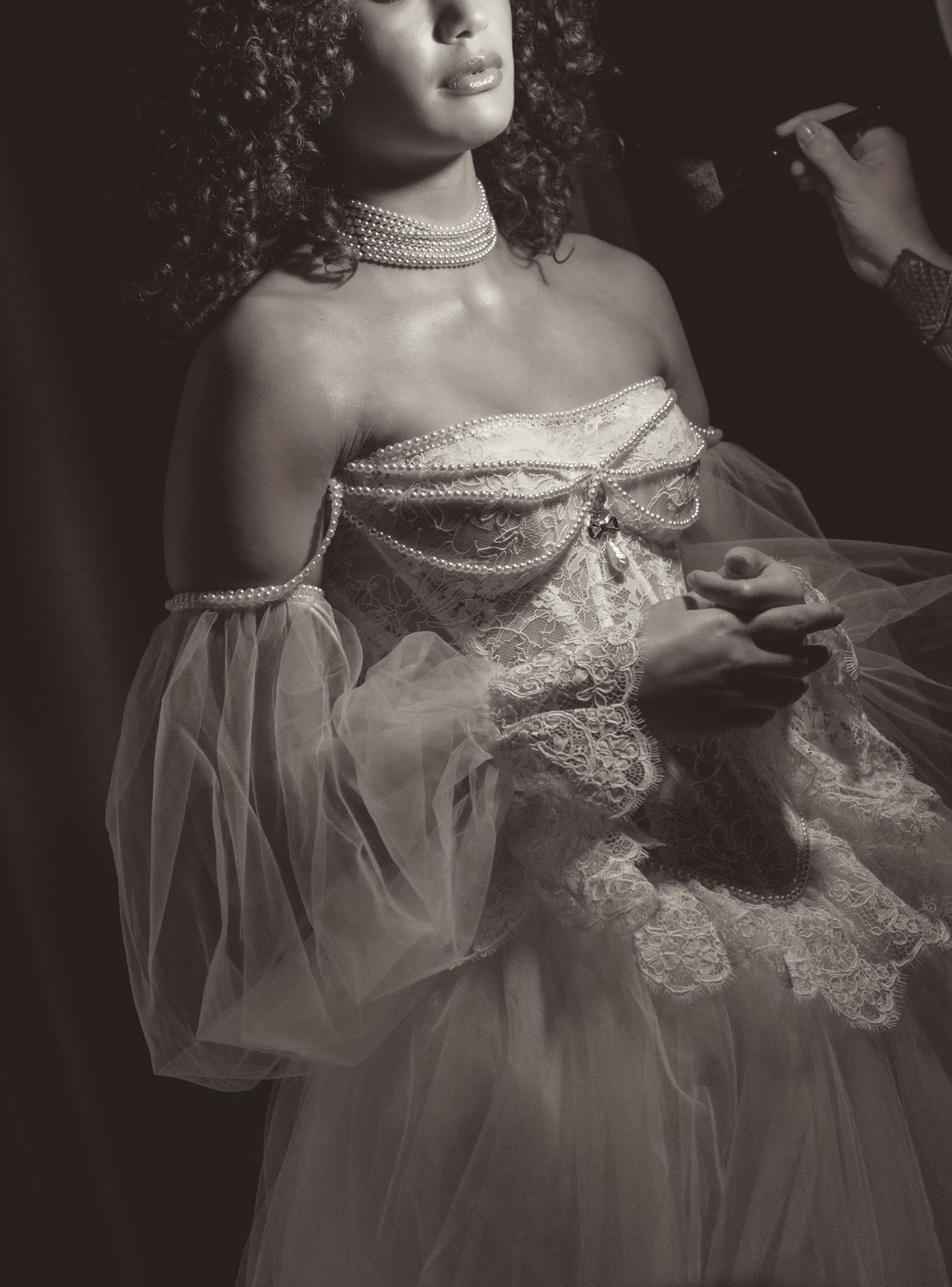 Dramatic black and white portrait series showing elegant lace and tulle details on a vintage-inspired dress.