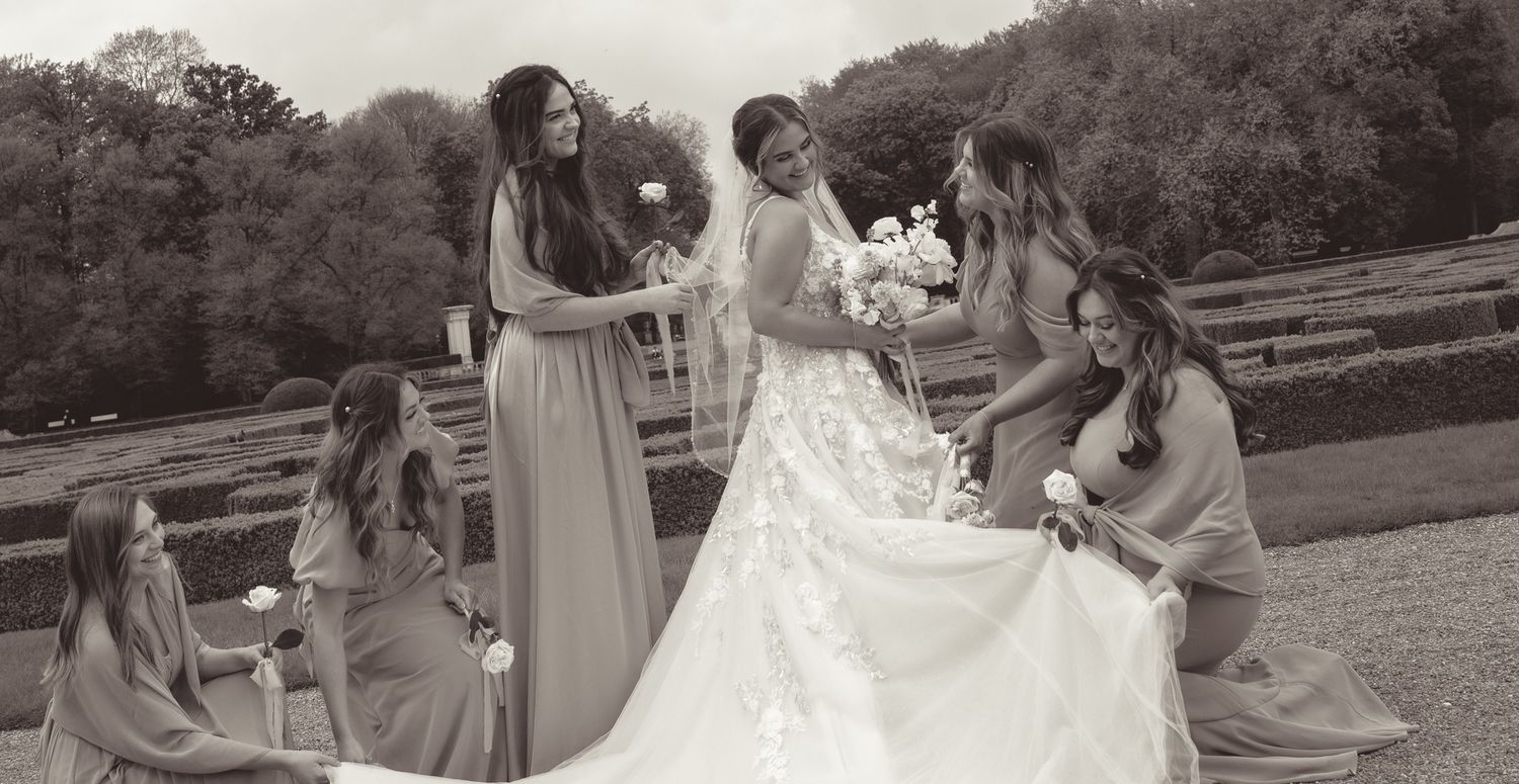 Natural outdoor wedding sequence with bride in flowing gown amid garden scenery.