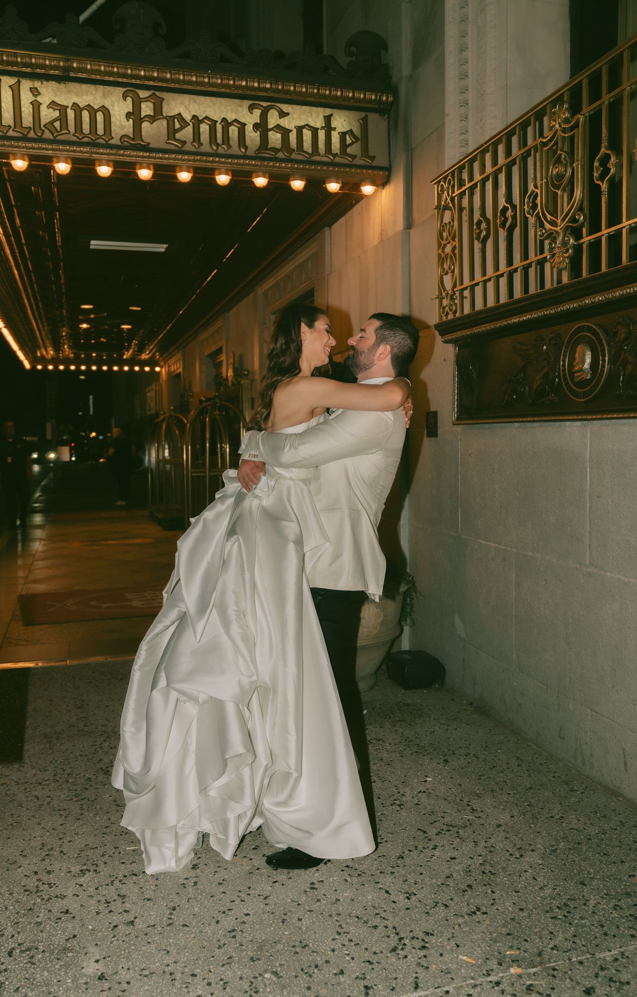 Intimate embrace between newlyweds under the William Penn Hotel in downtown pittsburgh, pa.