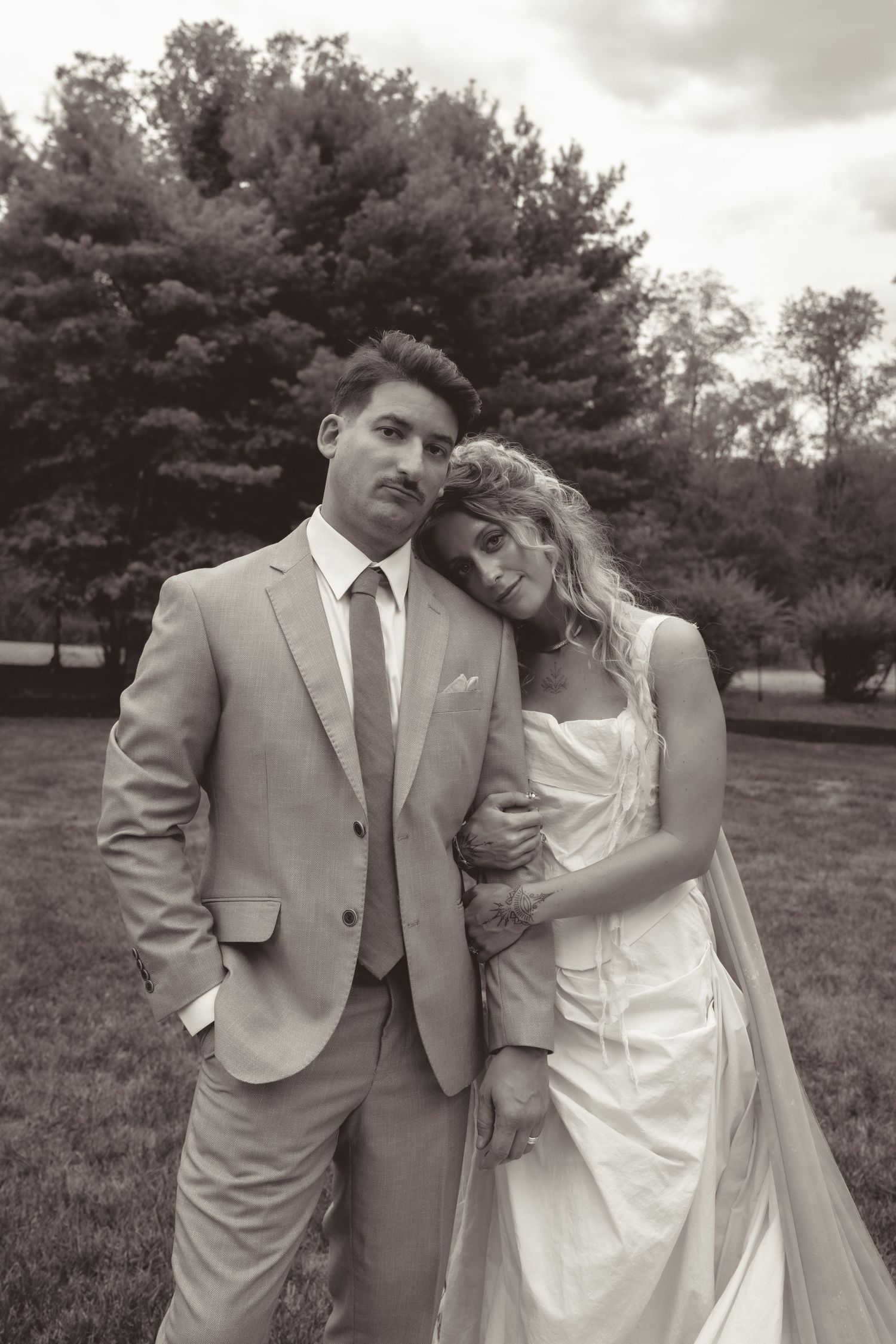 A romantic black and white wedding photo series showing tender moments between a couple.