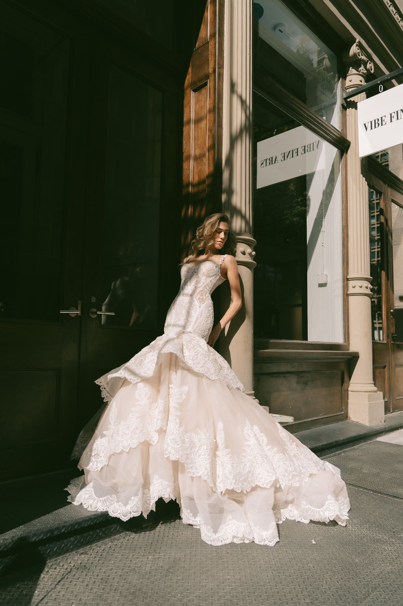 Dramatic wedding dress photos featuring intricate lace details against urban architecture.