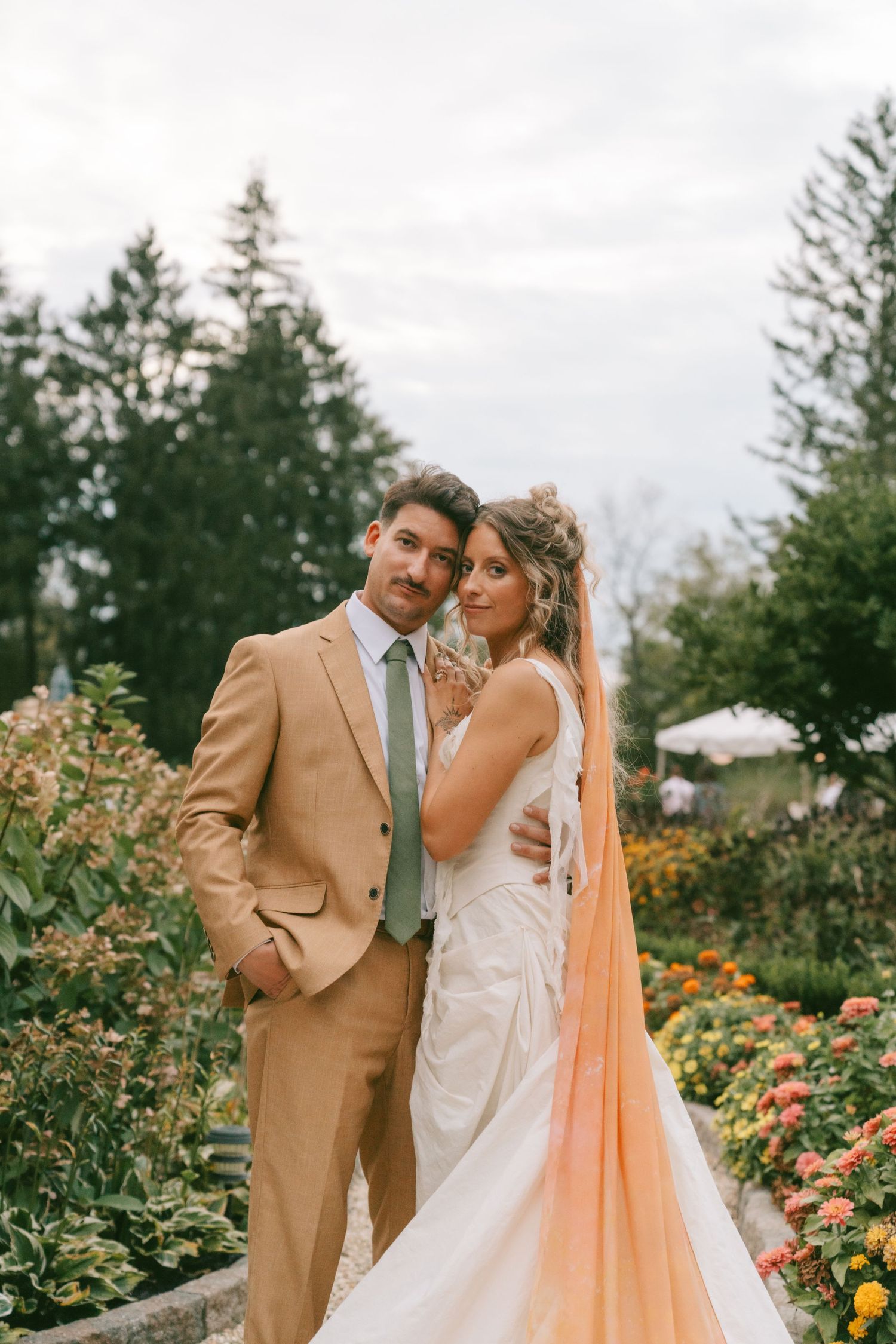 A romantic garden wedding photoshoot with soft lighting and blooming roses in the background.