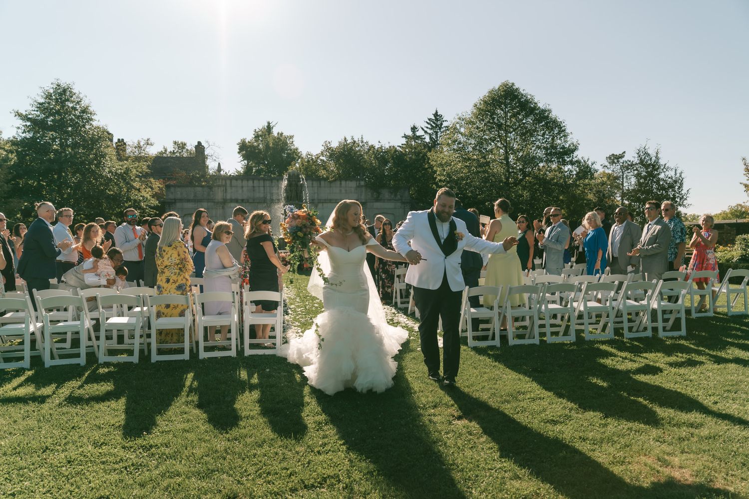 Outdoor wedding ceremony setup with white chairs and floral arrangements in downtown pittsburgh, pa.
