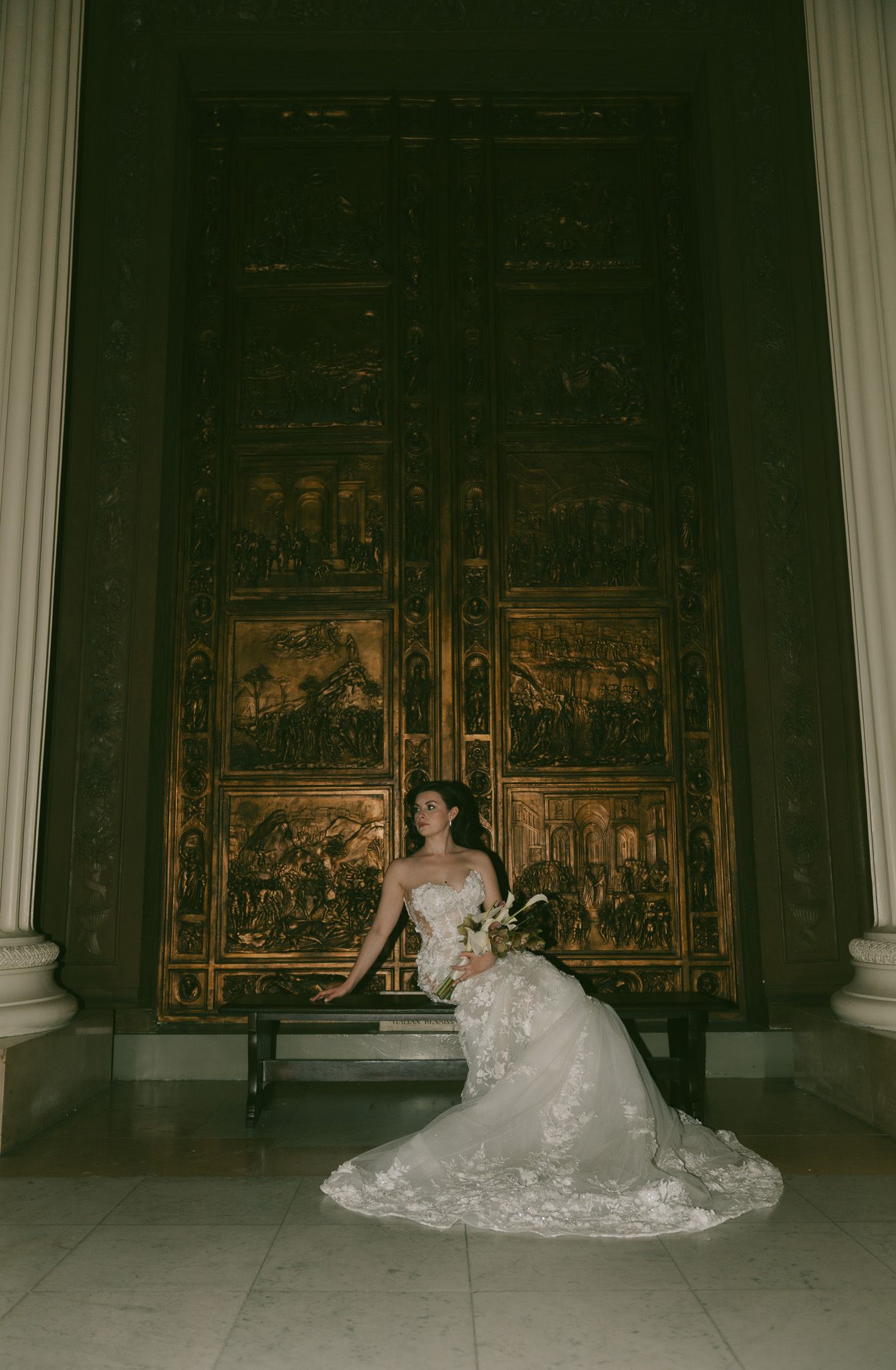 Dramatic wedding portraits in a gothic chapel with ornate gold altarpiece background.