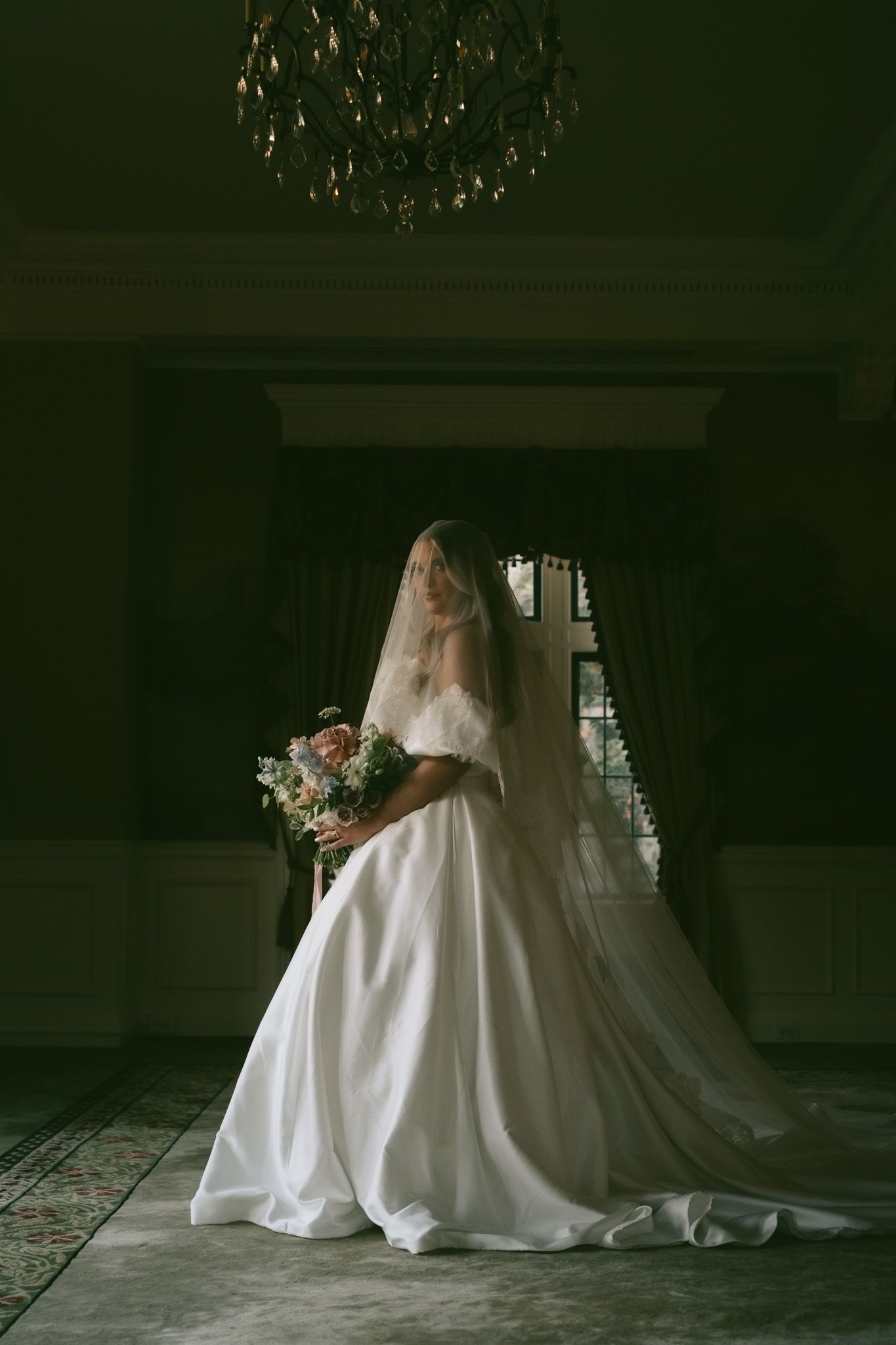 A moody series of bridal portraits showing a wedding dress silhouette against a dark, dramatic background.