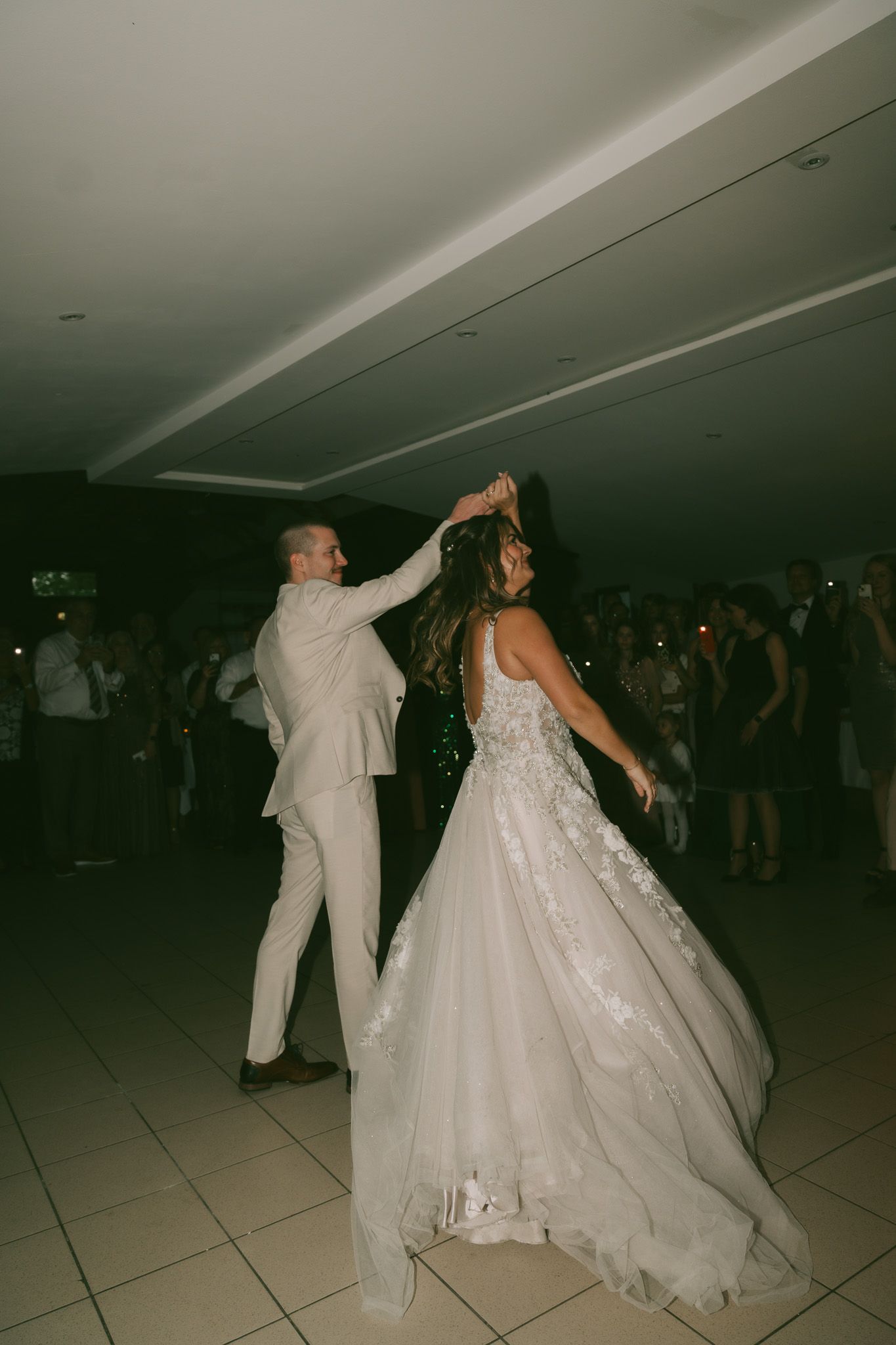 Wedding couple dancing together in formal attire on a reception dance floor in Germany.