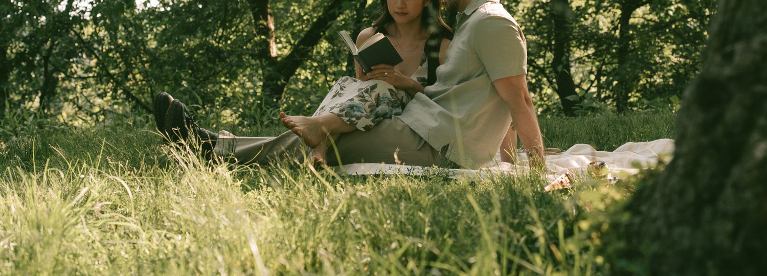 Soft focus image of people relaxing on grass at sunset in a lush green park setting at shenley park, pittsburgh.