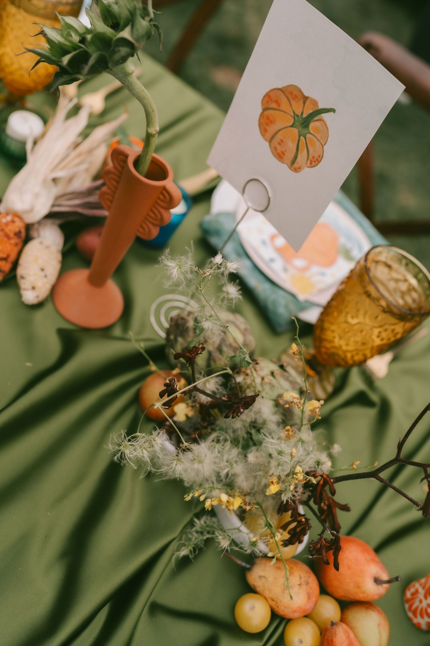 Autumn-themed wedding decor with pumpkins and delicate paper decorations.
