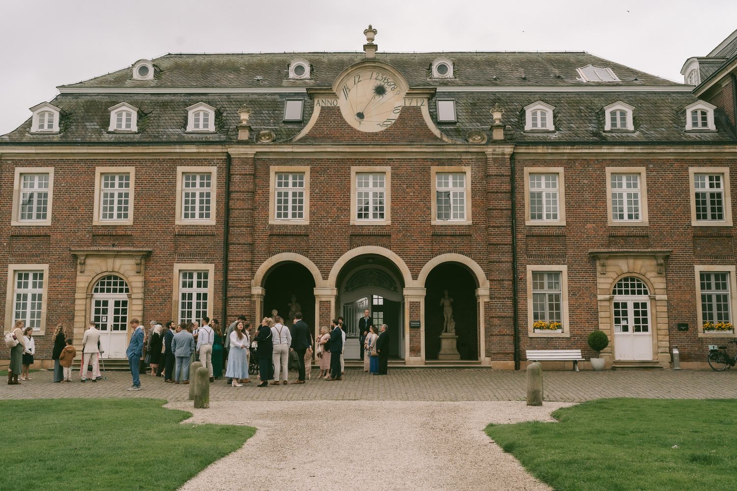 Grand brick building entrance with arched doorways and ornate architectural details in Germany.