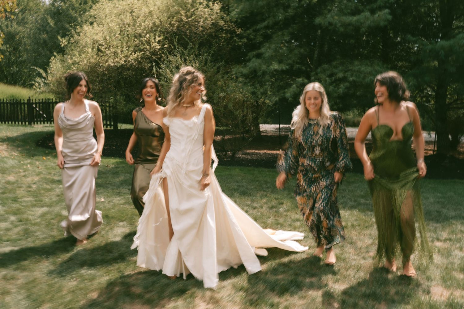 Group of wedding guests gathered outdoors on a sunny afternoon.