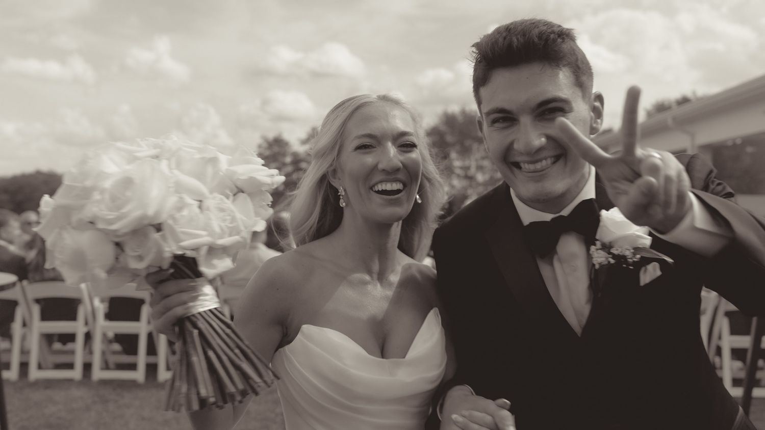 A candid wedding celebration moment captured in black and white with vintage styling.